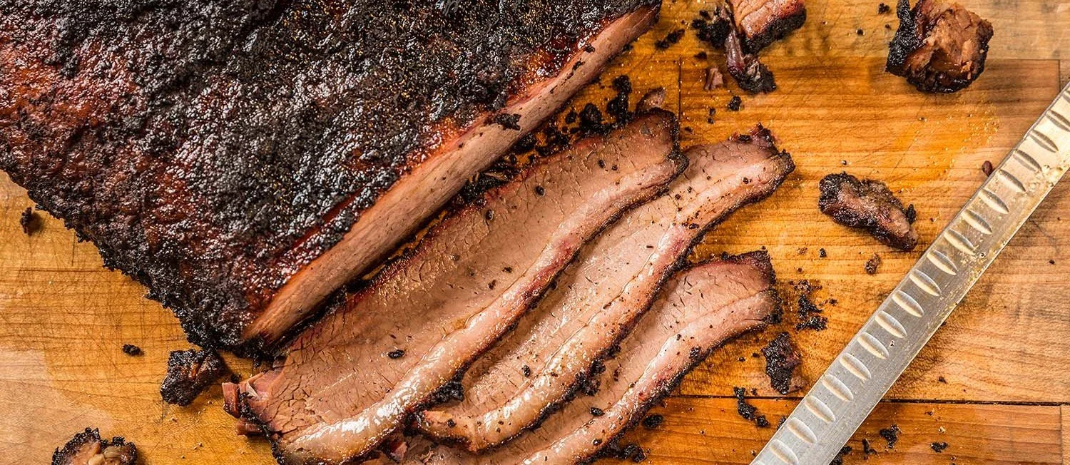 Sliced smoked brisket on a cutting board