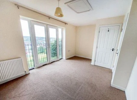 A room with French doors and a view over the city