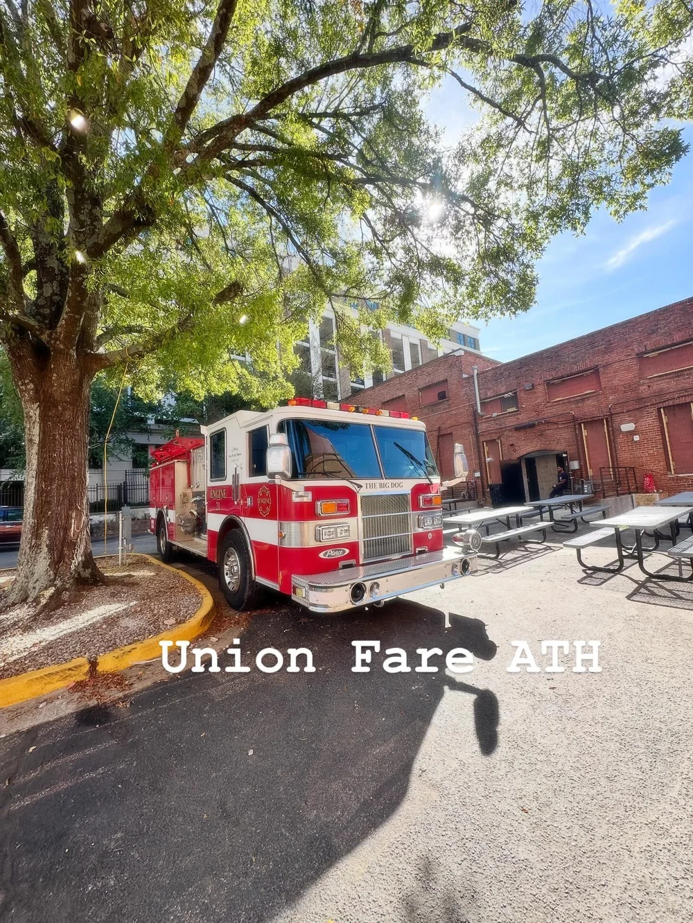 The red-and-white Big Dog fire engine beside outdoor tables at Union Fare in Athens.