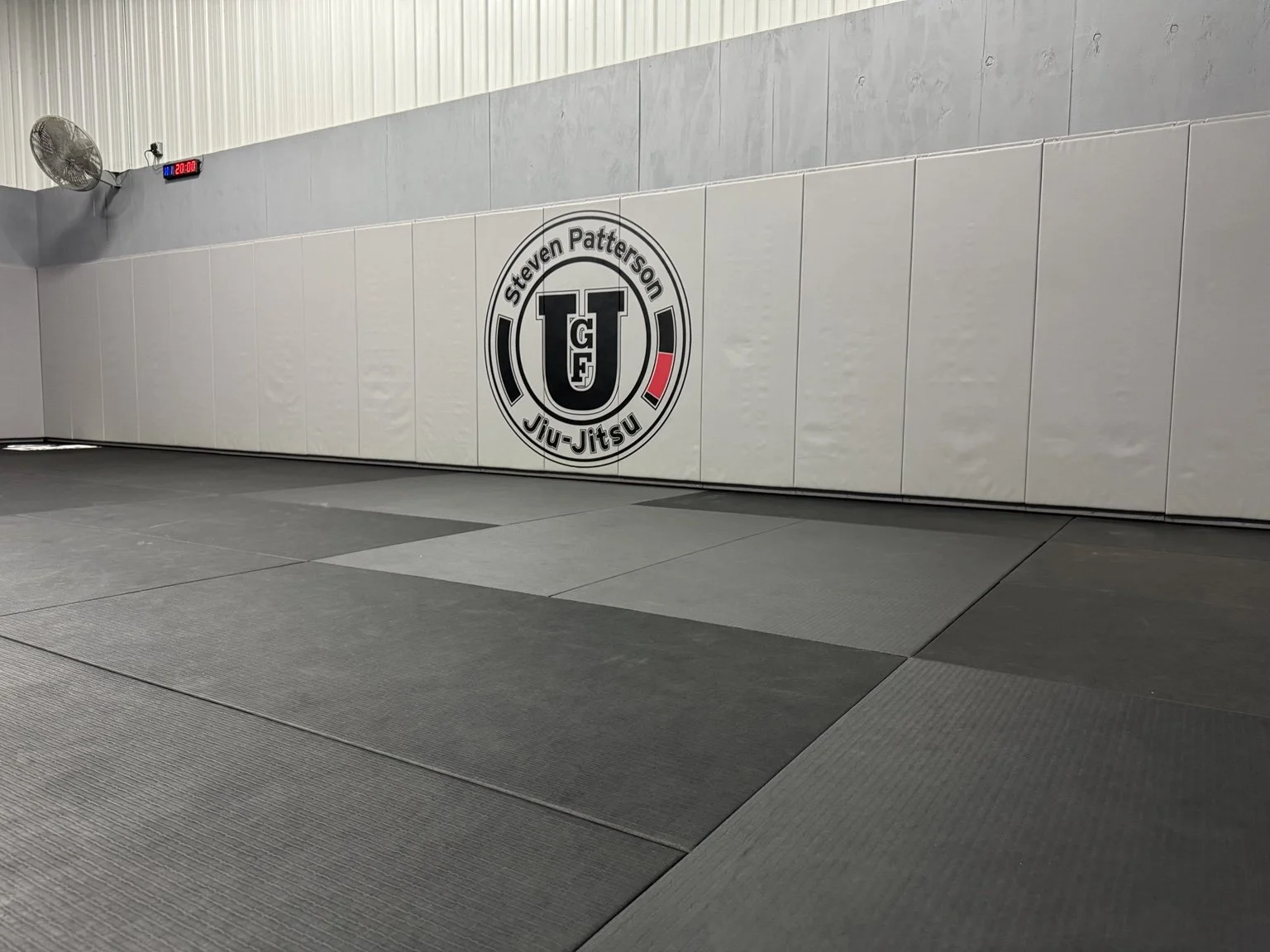 University of Ground Fighting training mat and wall logo in New Lenox, Illinois