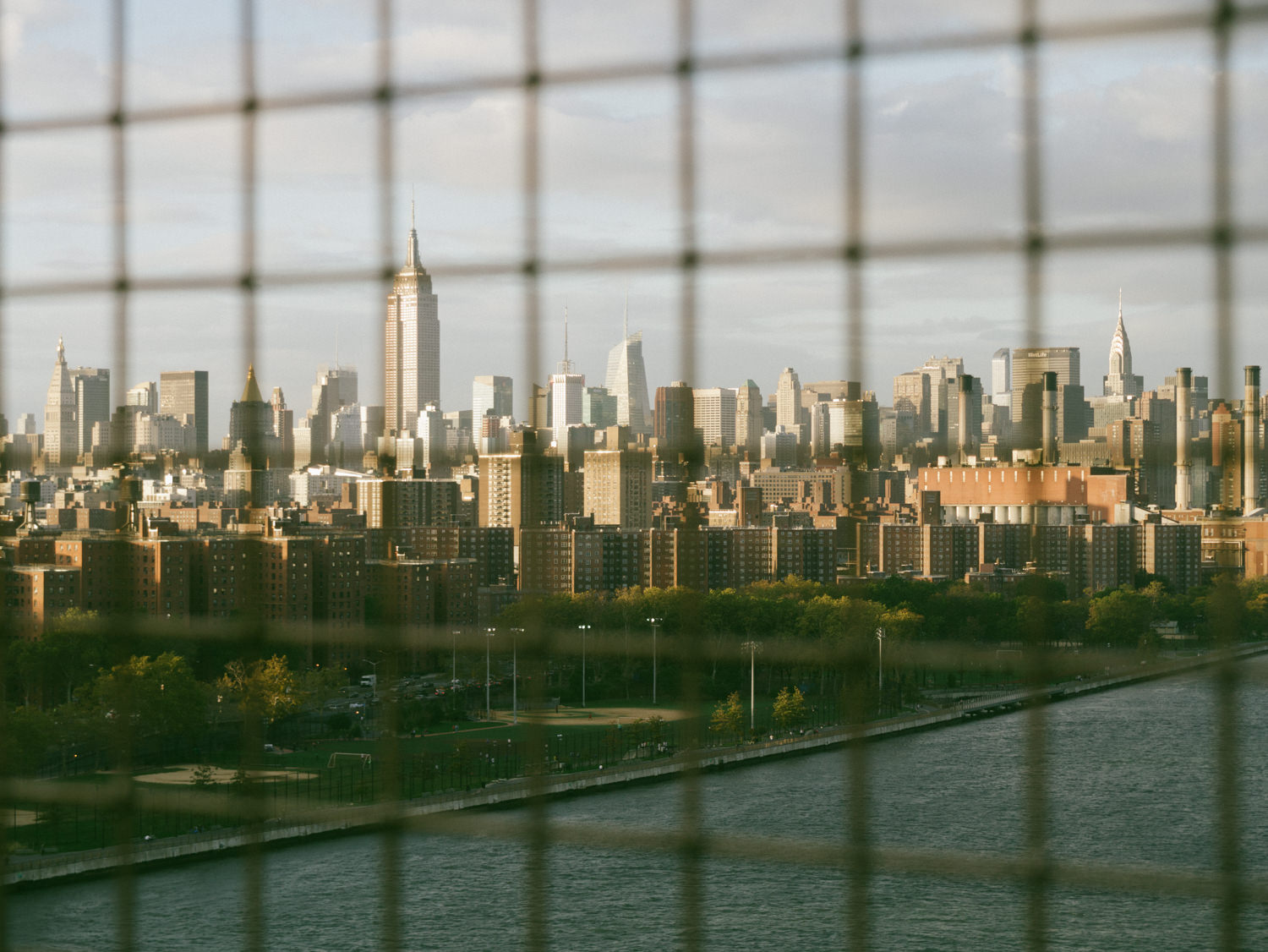 View of the East River Park and Alphabet City in the foreground. Empire State in the background
