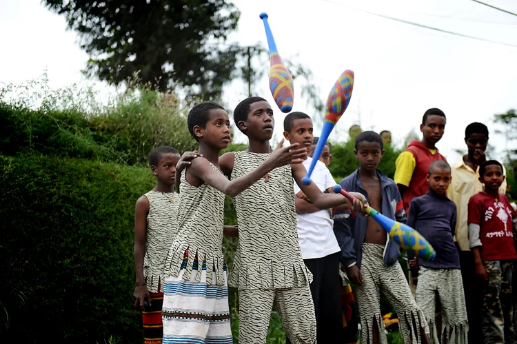 Boys juggle together at the Mary Joy Aid Through Development . This particular segment of their performance was preceded by a mime, where the boy on the right "taught" the boy on the left to juggle. Apparently he's a good learner.