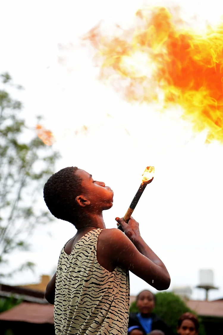 Yes, this child is eating fire -- and well , by the way. He was fantastic. It was only after I left Mary Joy and was processing this photo did it dawn on me that perhaps this wasn't the safest activity to teach a young boy.