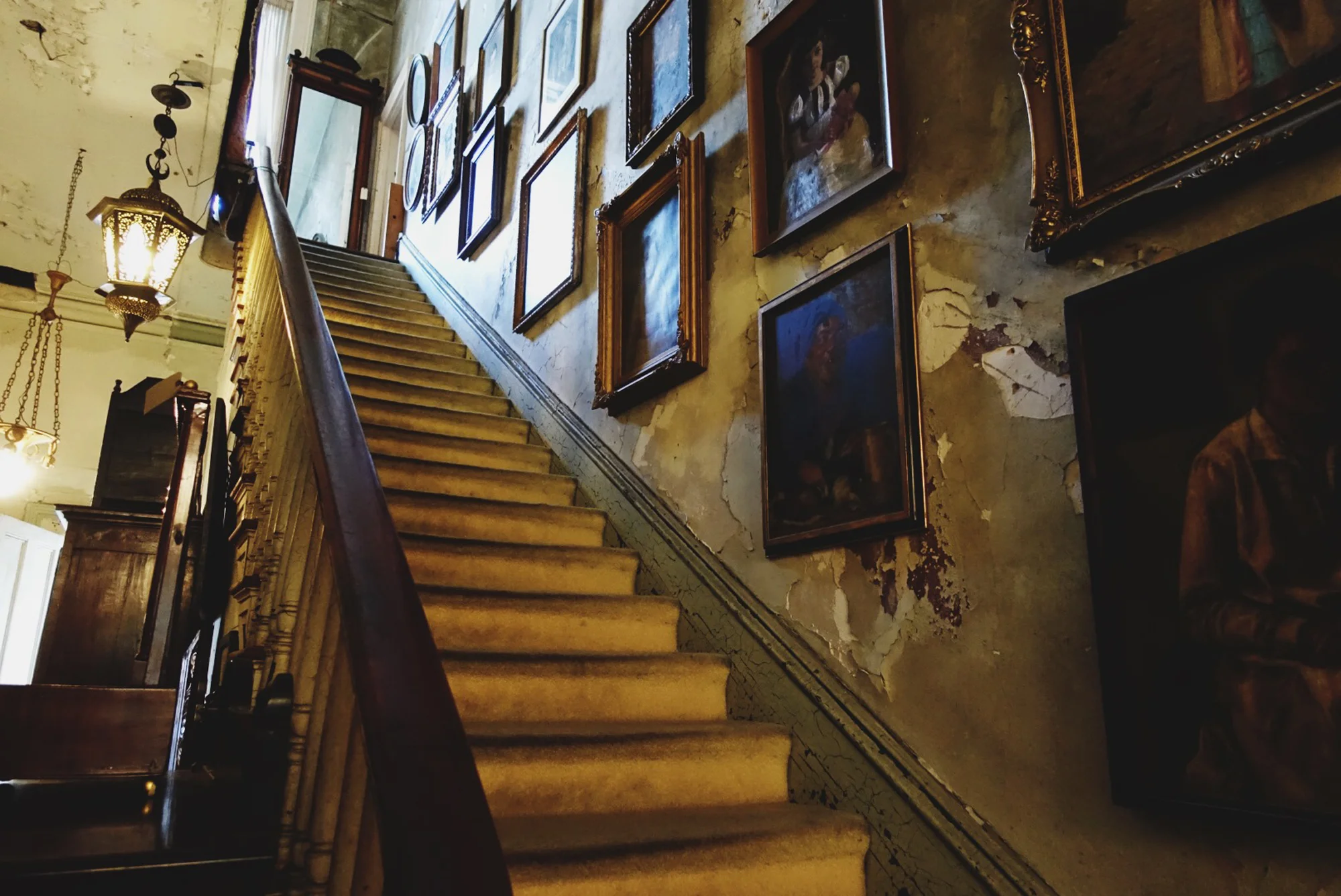 The owner of the Alex Raskin Antiques store let us go upstairs into the closed area of the huge building. It was incredible, and photos don’t do it justice. Also the manager told me that despite the creepy paintings and dark corners, there aren’t any stories of hauntings in this building — but the painting of the freakishly large-headed baby whose eyes followed us going down this staircase was still unsettling.