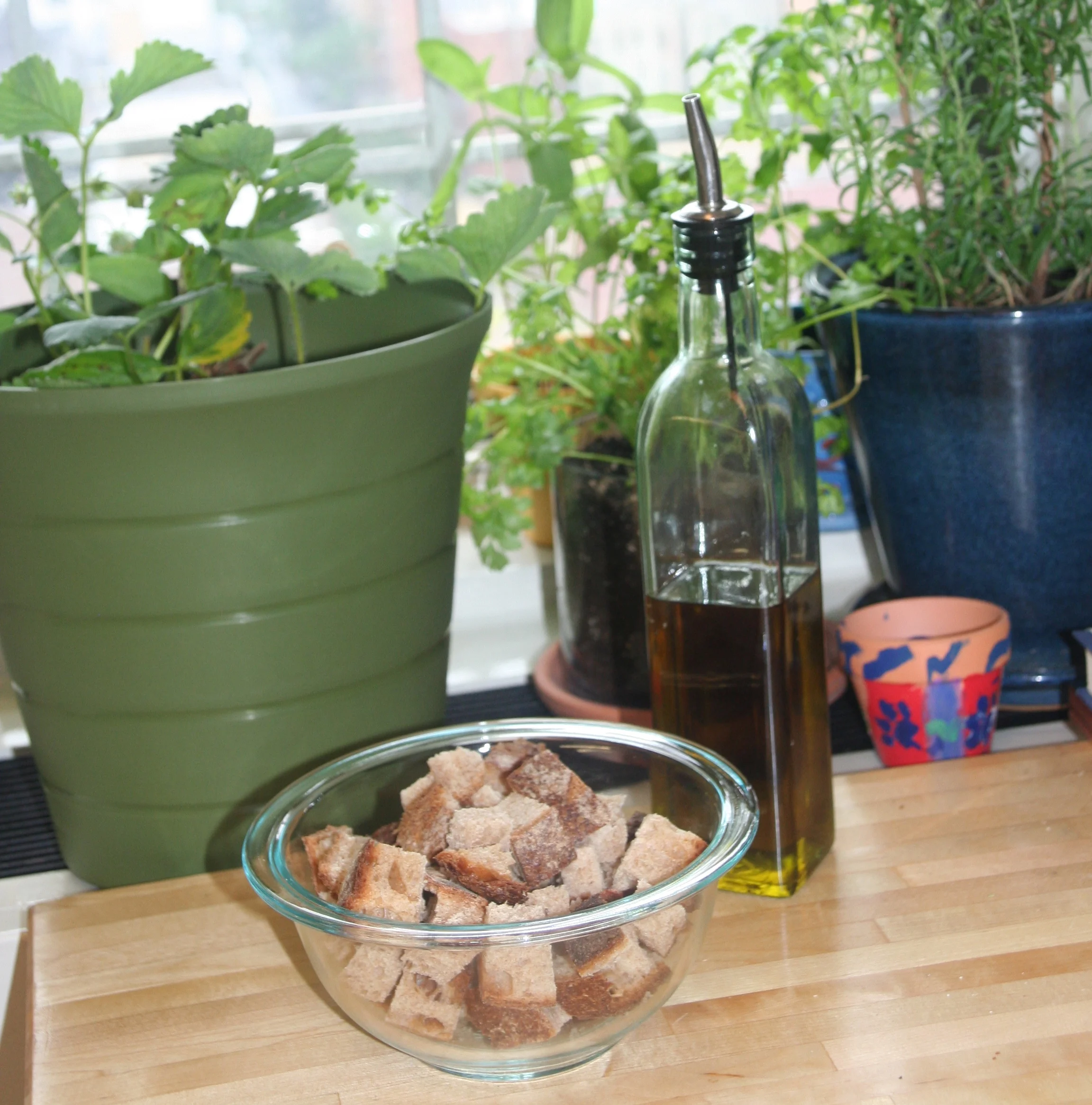 First, I cut the whole wheat bread into crouton chunks and put them into a mixing bowl.