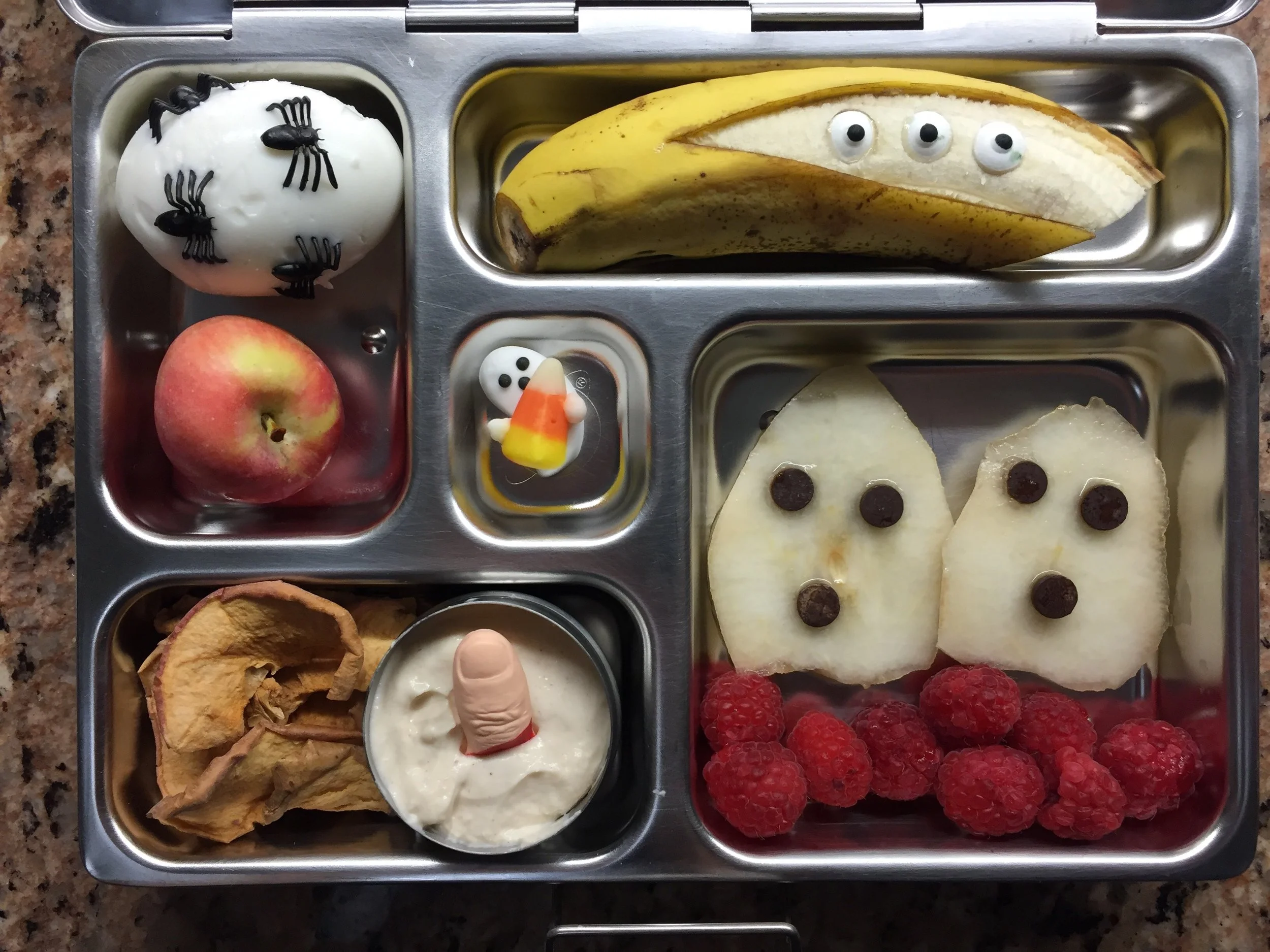 My personal fave: pear ghosts with berries, yogurt with a candy finger and dried apple, spider egg, banana ghost.