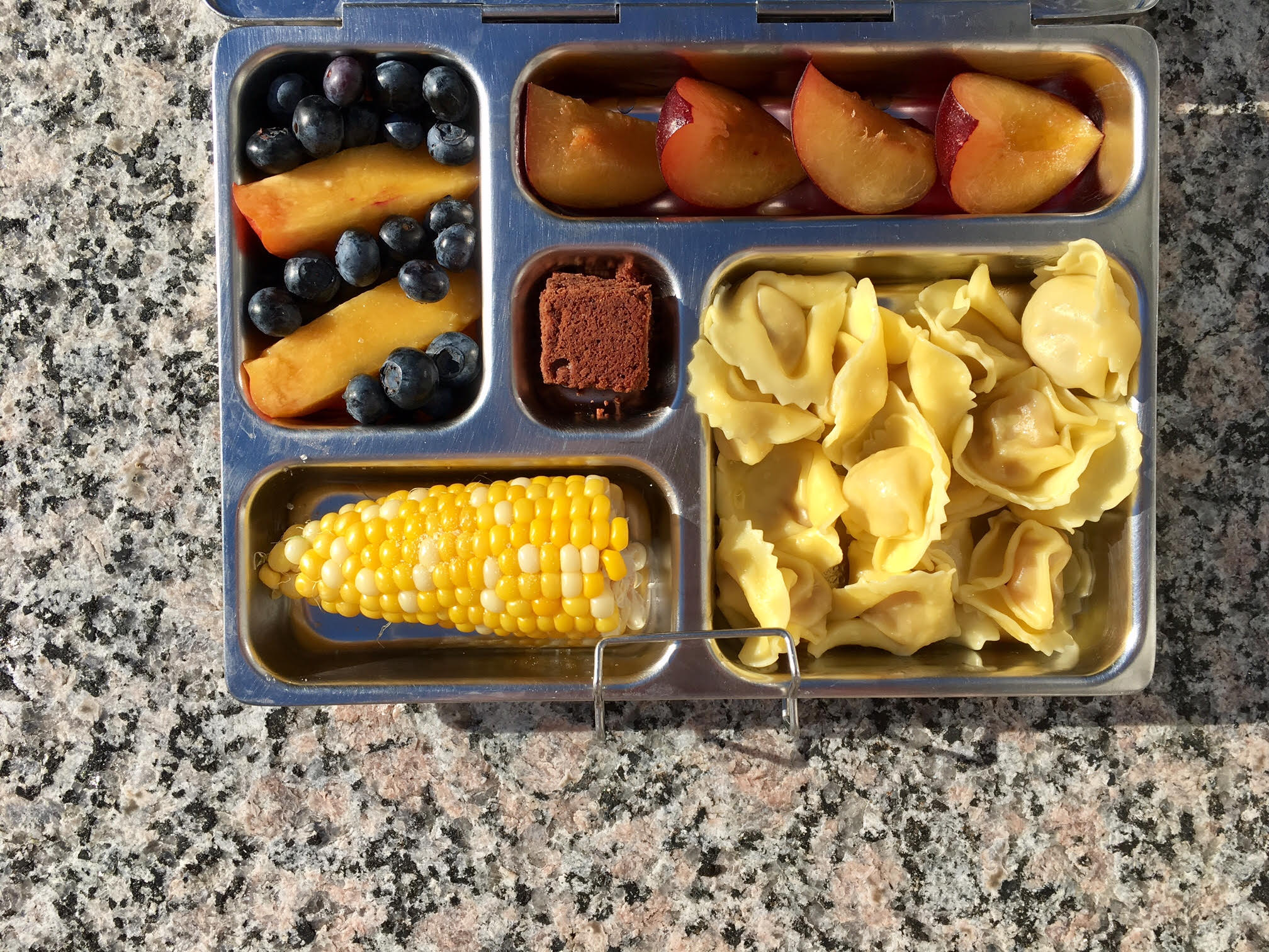 tortellini, plum, nectarine, blueberries, leftover corn and a brownie bite