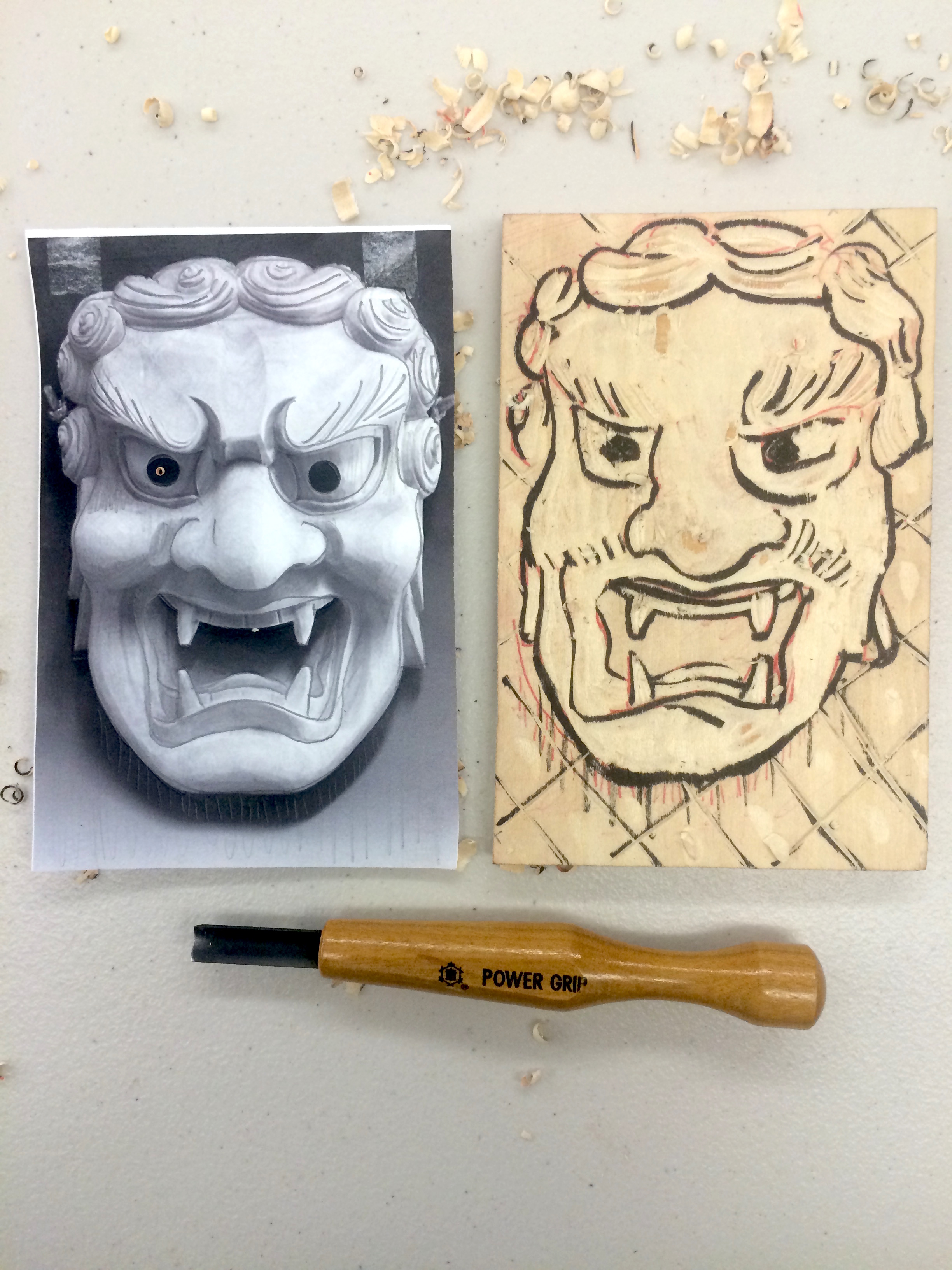Carving out the image on the woodblock.