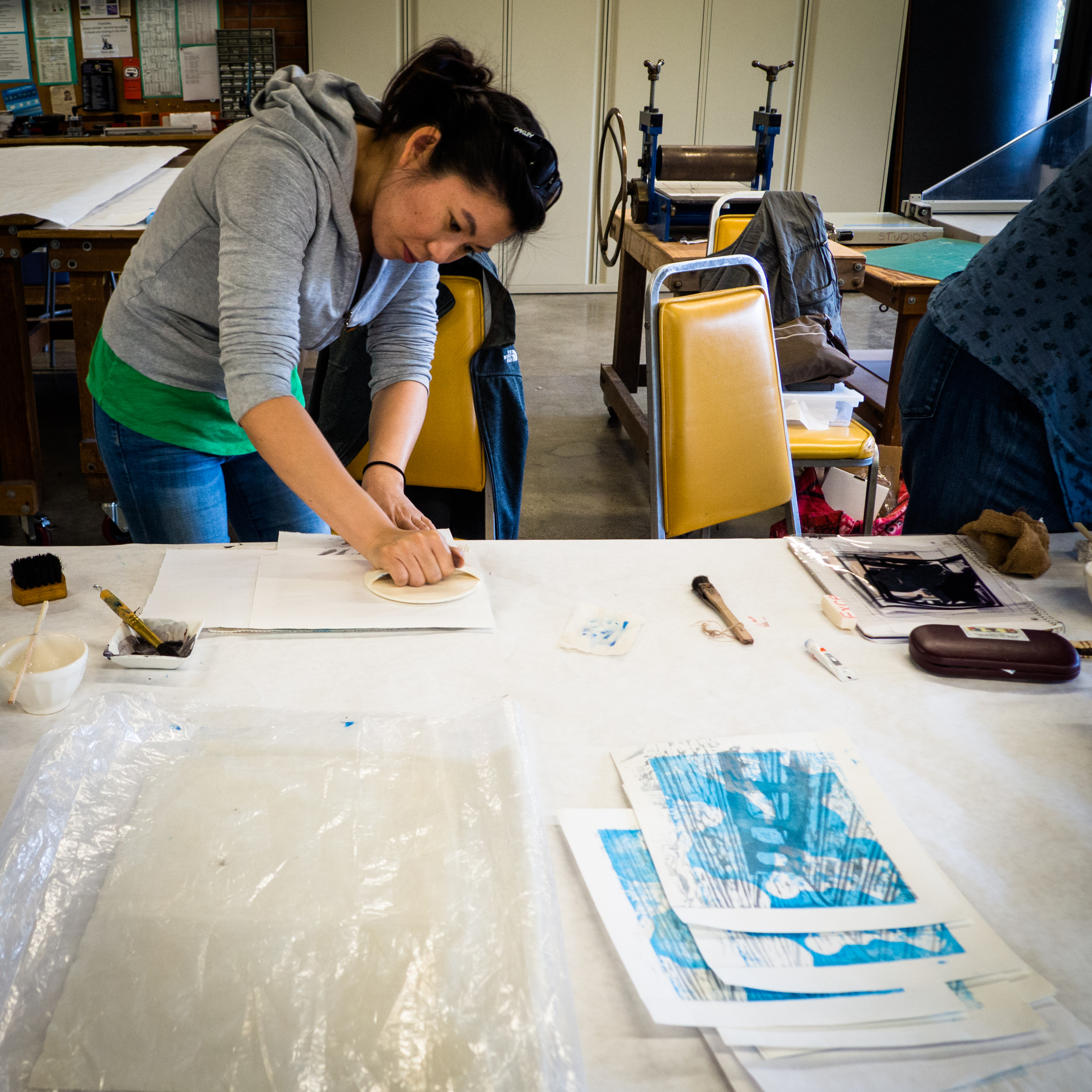 Jennifer prints her two plate woodblock at the art center.