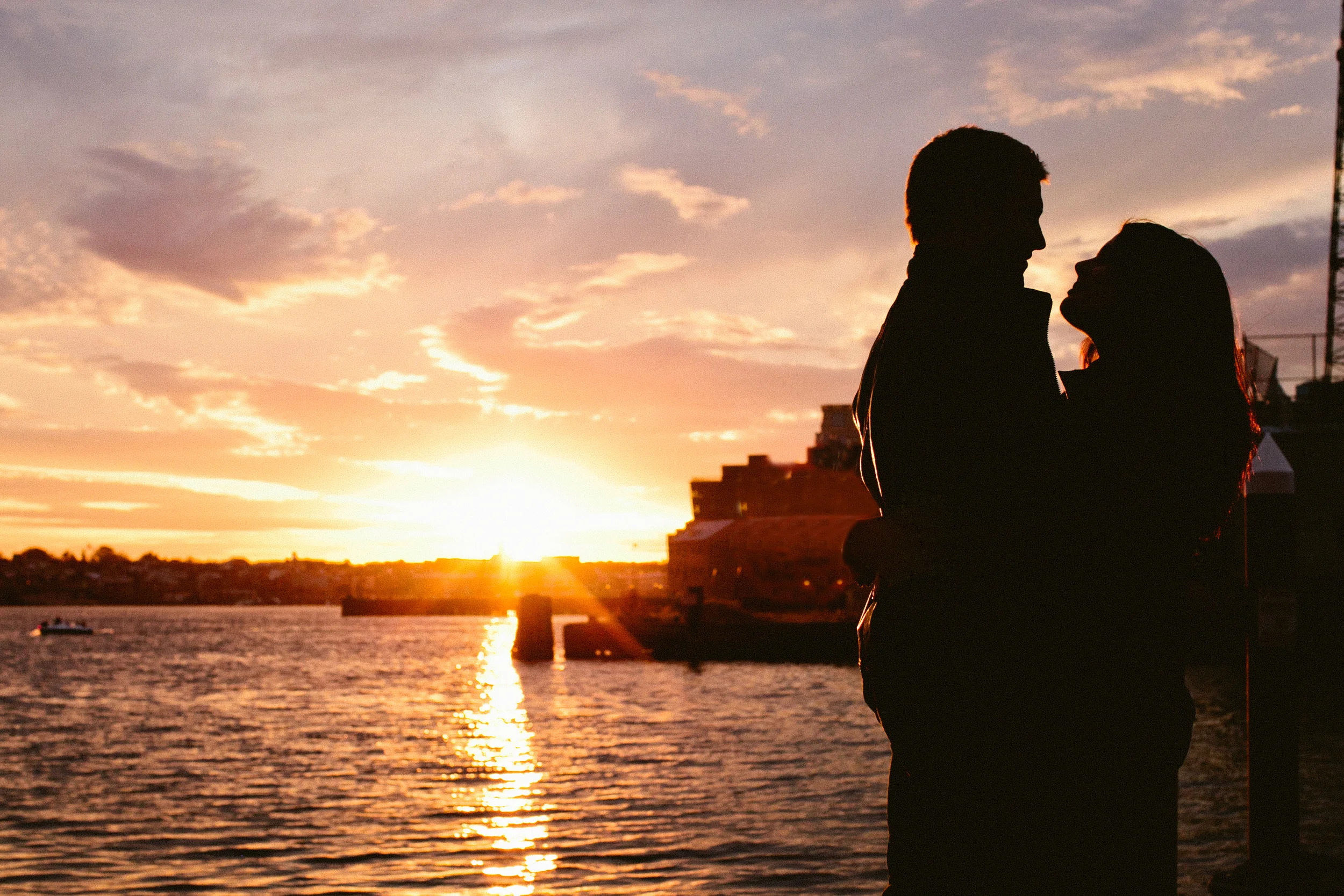Silhouette sunset shot of engaged couple on docks of Fells Point in Baltimore, MD - Maria Vicencio Photography Engagement Session