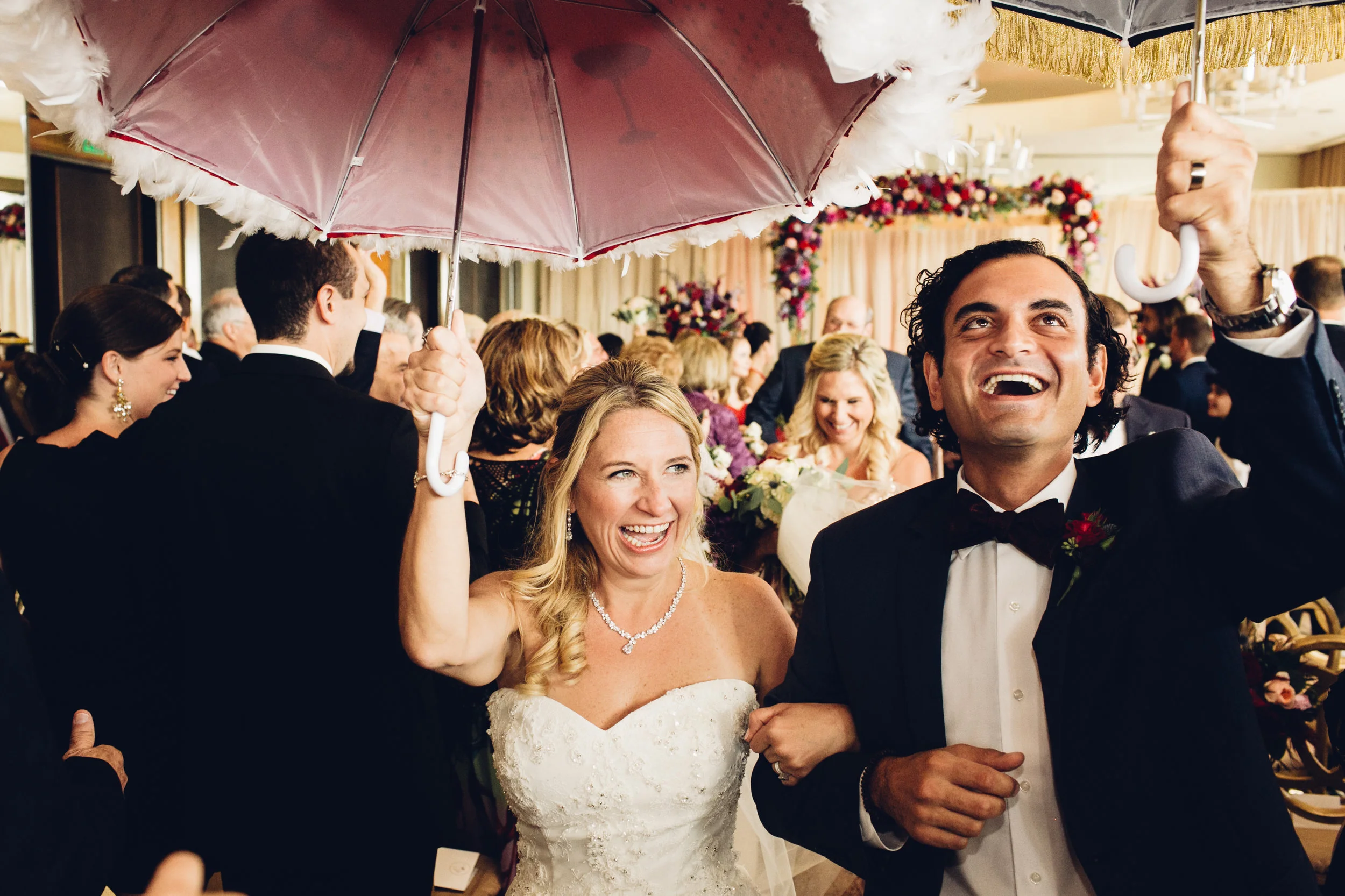 Happy bride and groom during second line after ceremony at the Four Seasons Baltimore - Maria Vicencio Photography Weddings