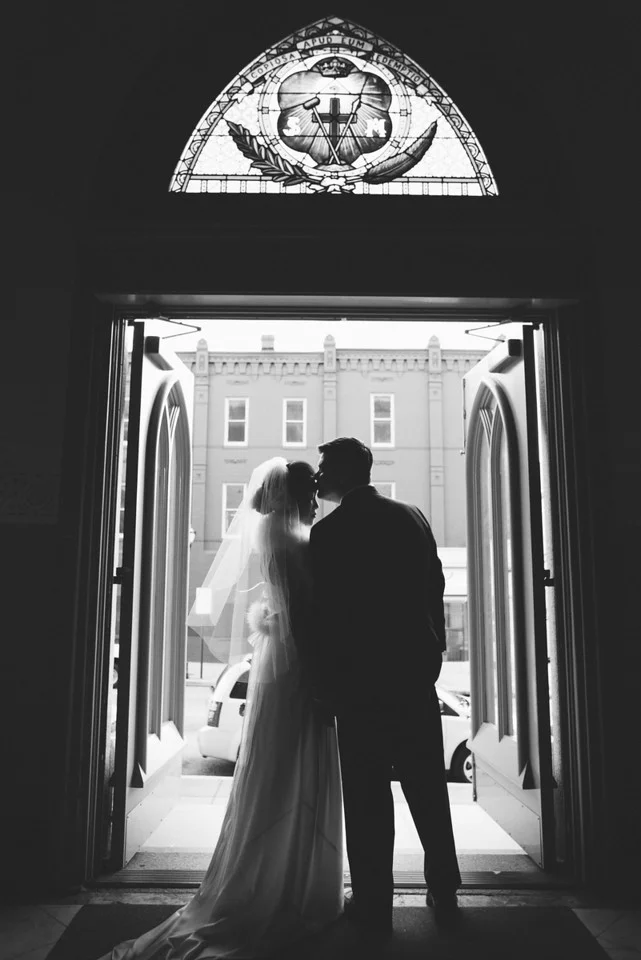 Black and white silhouette shot of bride and groom in doorway of St. Alphonsus Church in Baltimore - Maria Vicencio Photography Weddings
