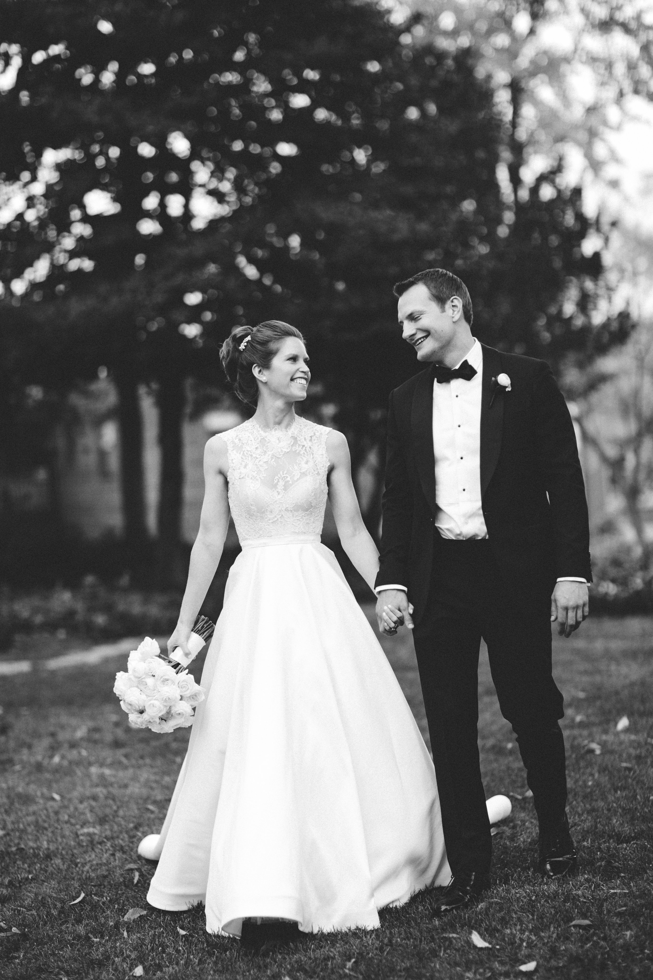 Black and white shot of bride and groom walking at Meridian House in DC - Maria Vicencio Photography Weddings