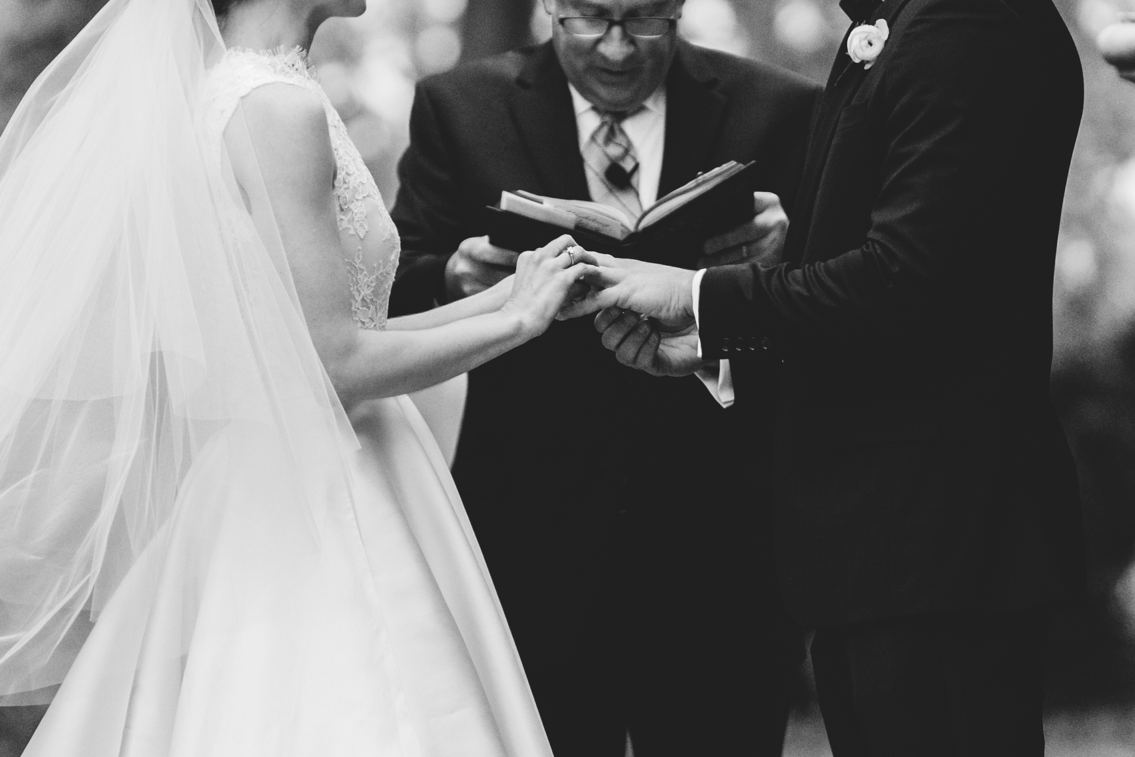 Black and white closeup shot of bride and groom exchanging rings during ceremony at Meridian House in DC - Maria Vicencio Photography Weddings