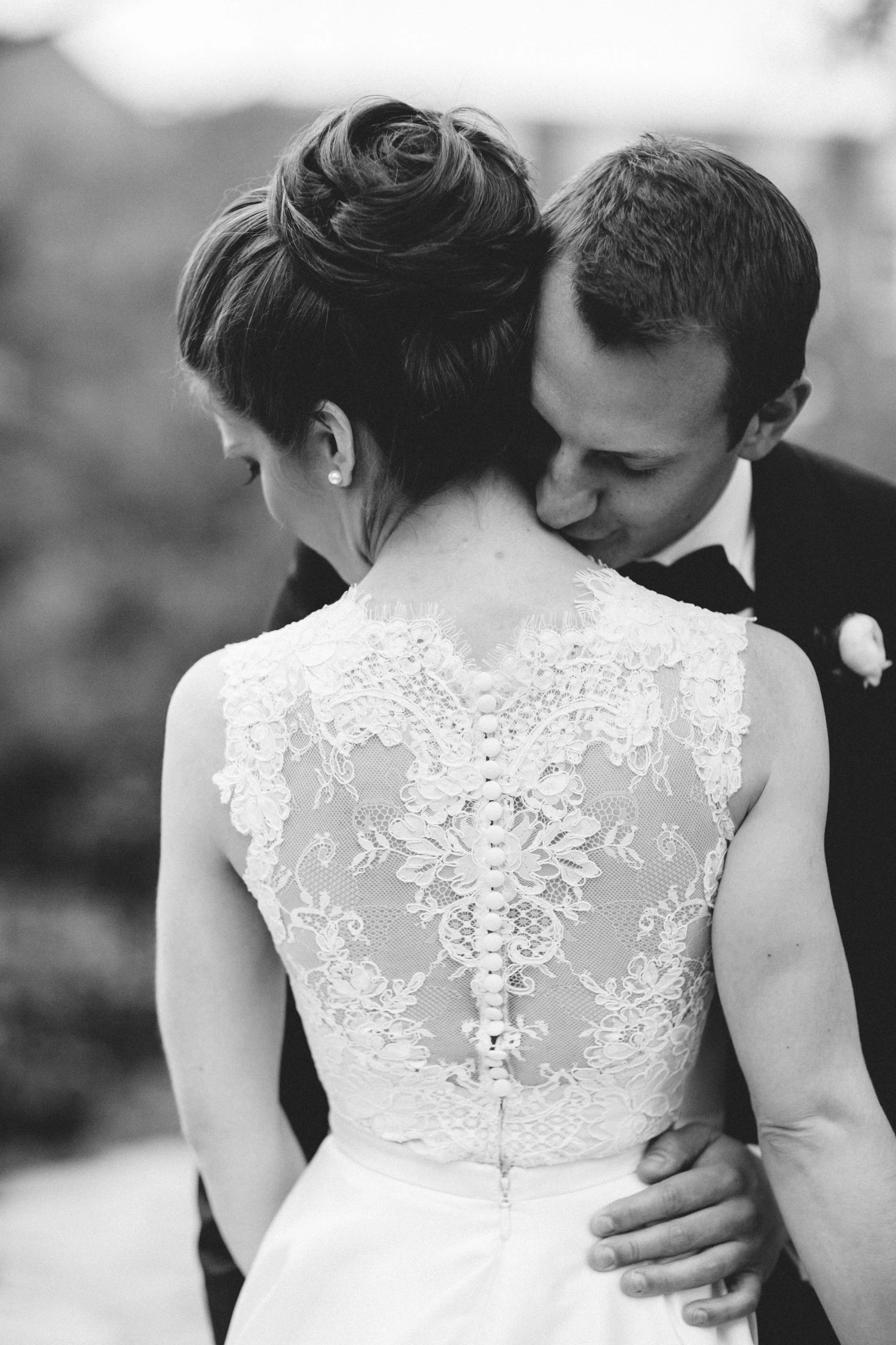 Black and white shot of groom kissing bride's neck at Meridian House in DC - Maria Vicencio Photography Weddings