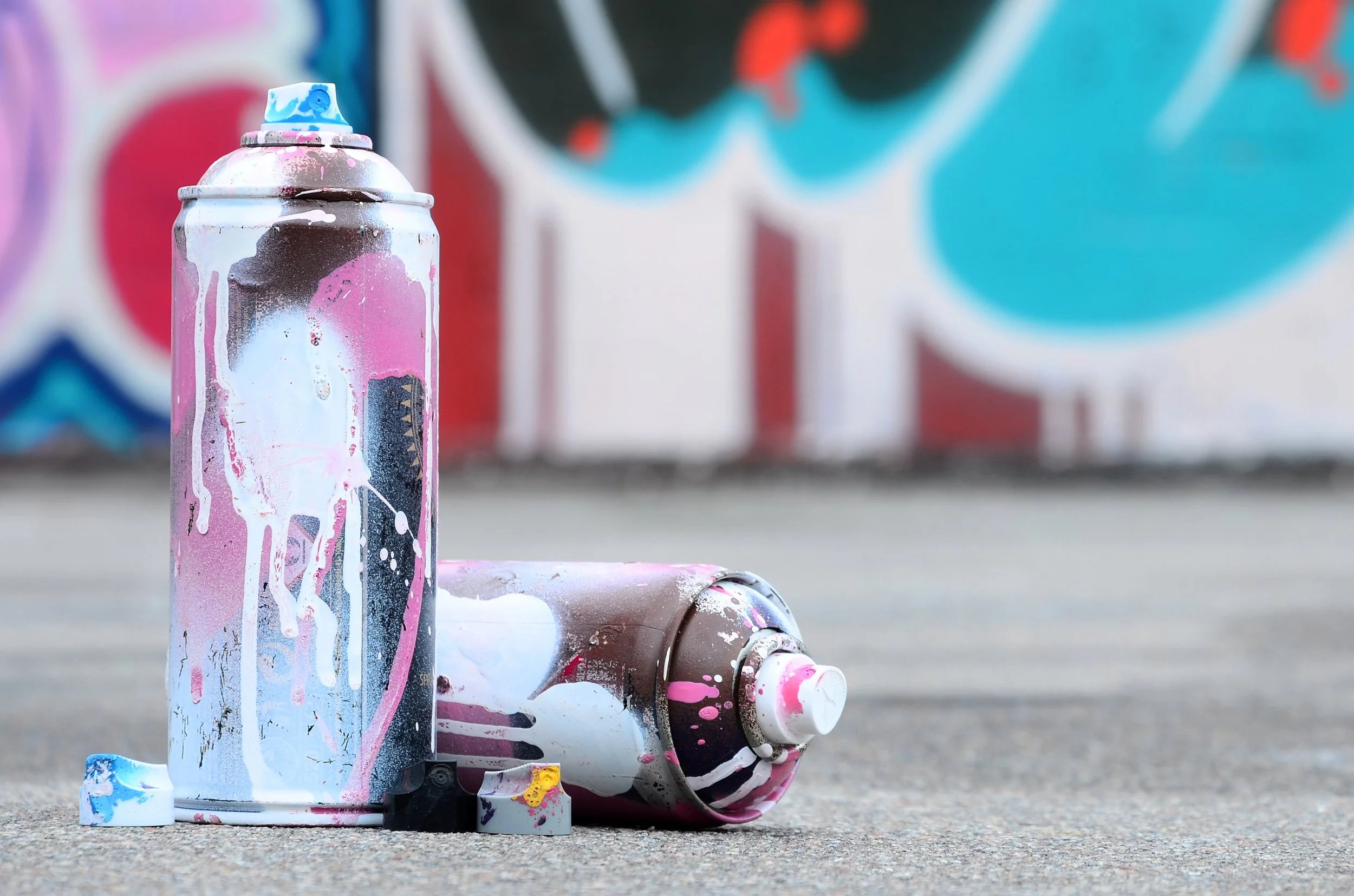 several-used-spray-cans-with-pink-and-white-paint-2023-11-27-05-23-47-utc.jpg
