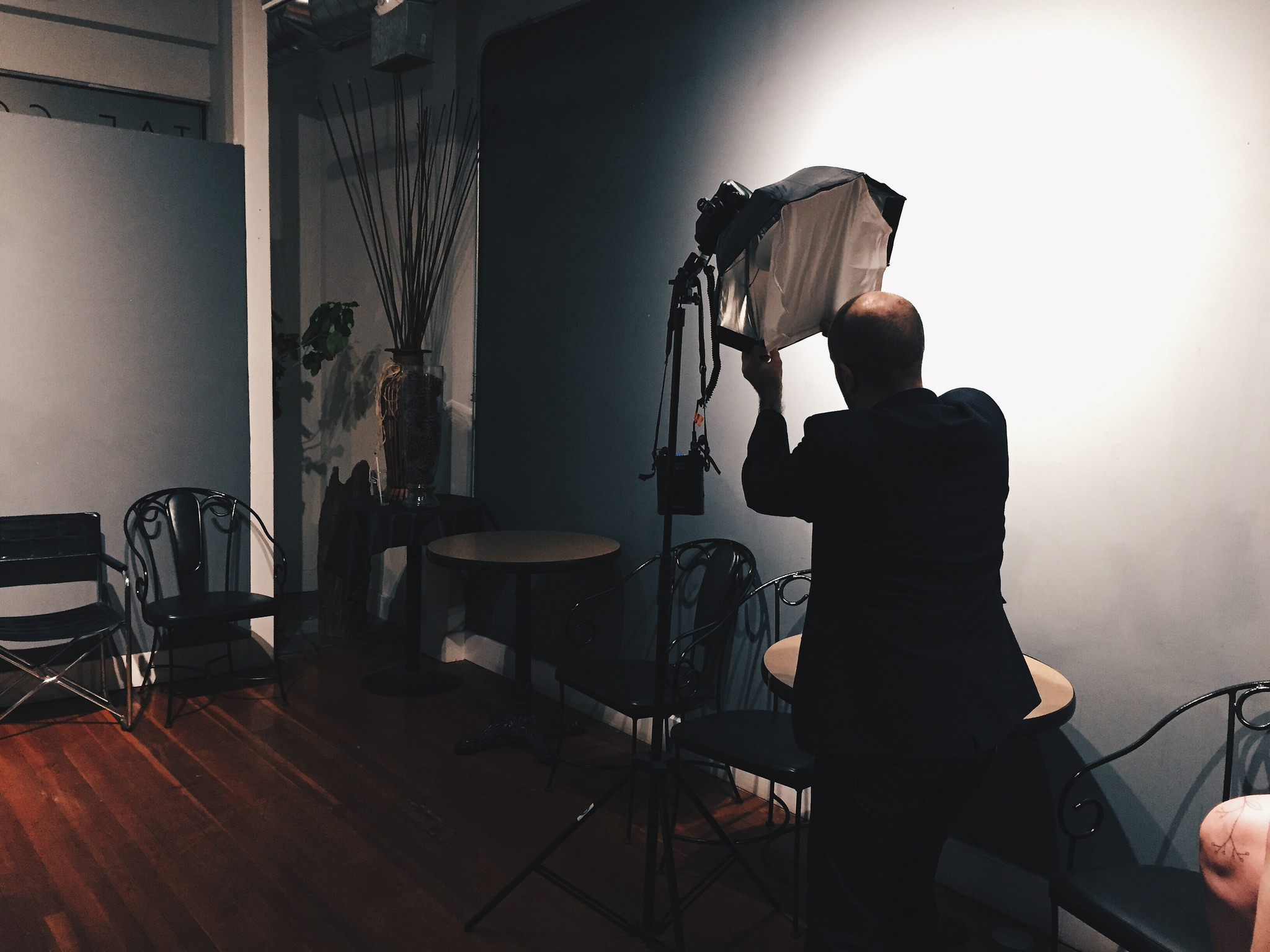 Aidan setting up lighting for a photo shoot for Kindred Cities .
