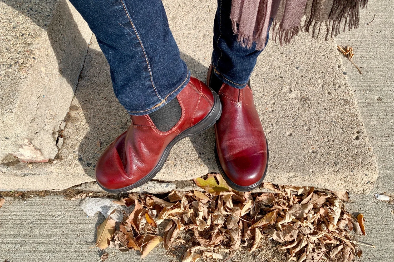 my feet on an old sidewalk showing off a new pair of redwood Blundstone boots