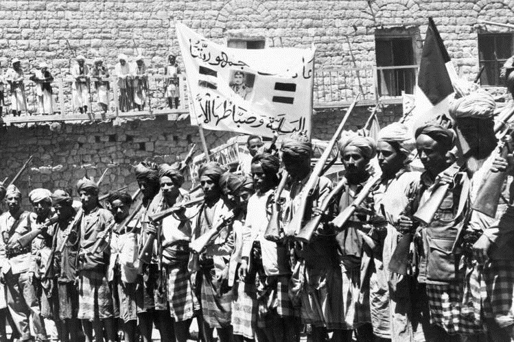 Militiamen mark the overthrow of Imam al-Badr; Sallal is on the banner, 1962 - Sana'a (AP)