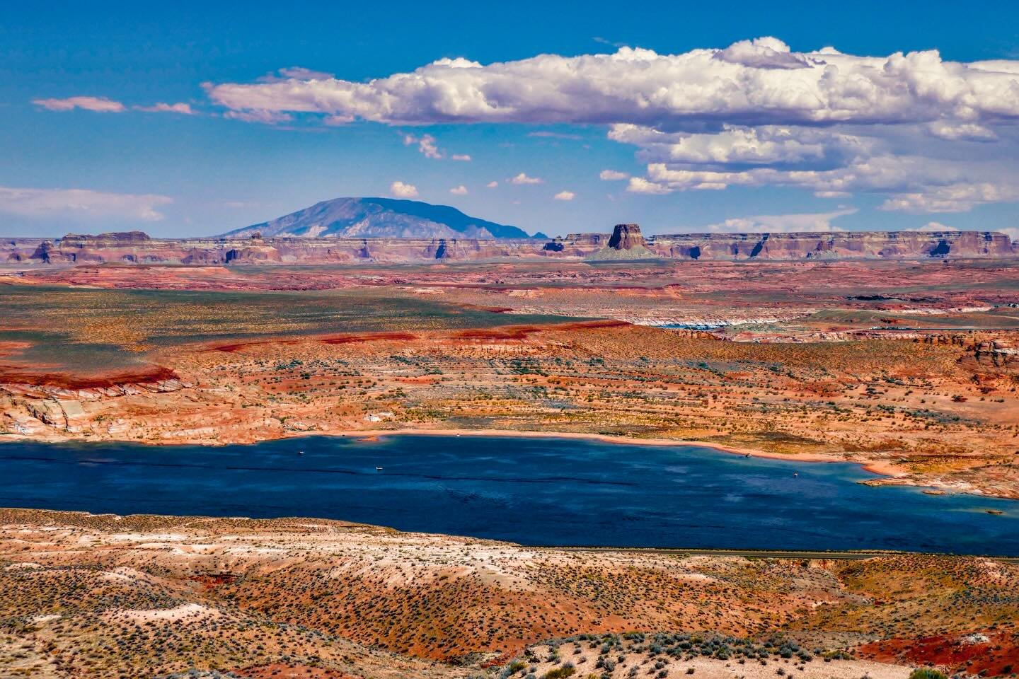 &ldquo;Your Land&rdquo; &copy; 2025 Skip Hunt

A vast desert landscape stretches across the scene, with a deep blue lake in the foreground. Rugged hills and distant mesas are set beneath a sky scattered with fluffy clouds.

Lake Powell, Arizona