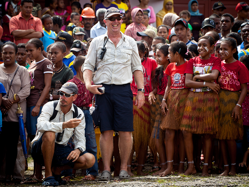 Mark and Mick surrounded by kids from the village