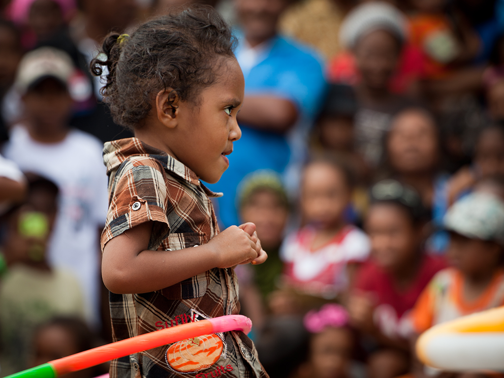 Young hula hoop dancer concentrating on her performance