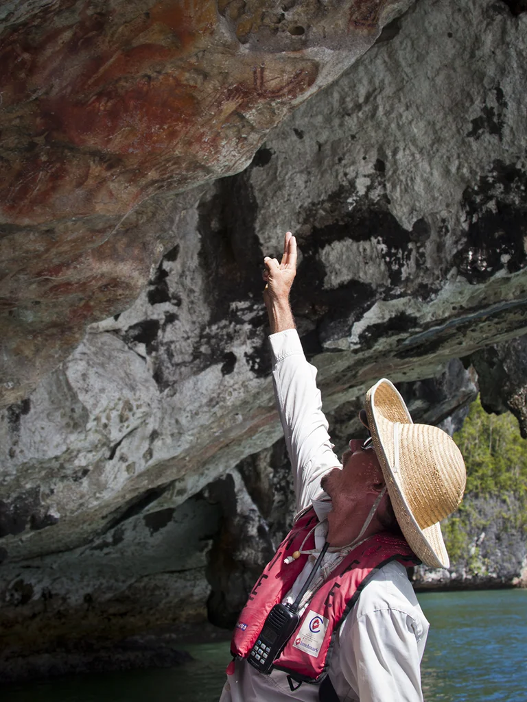 Mark points out the rock art