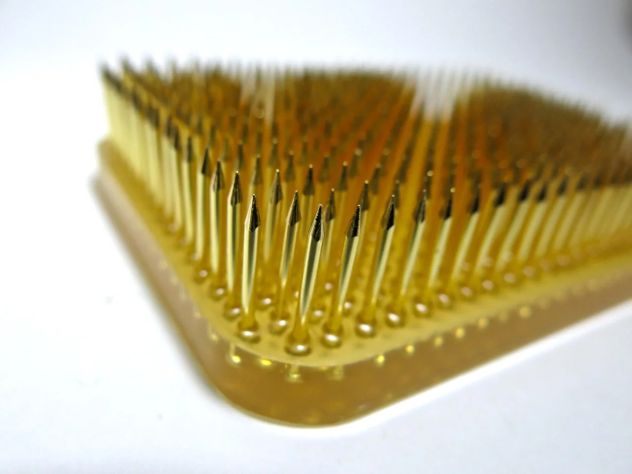 Brass pins on hard polyester resin. No lead used.