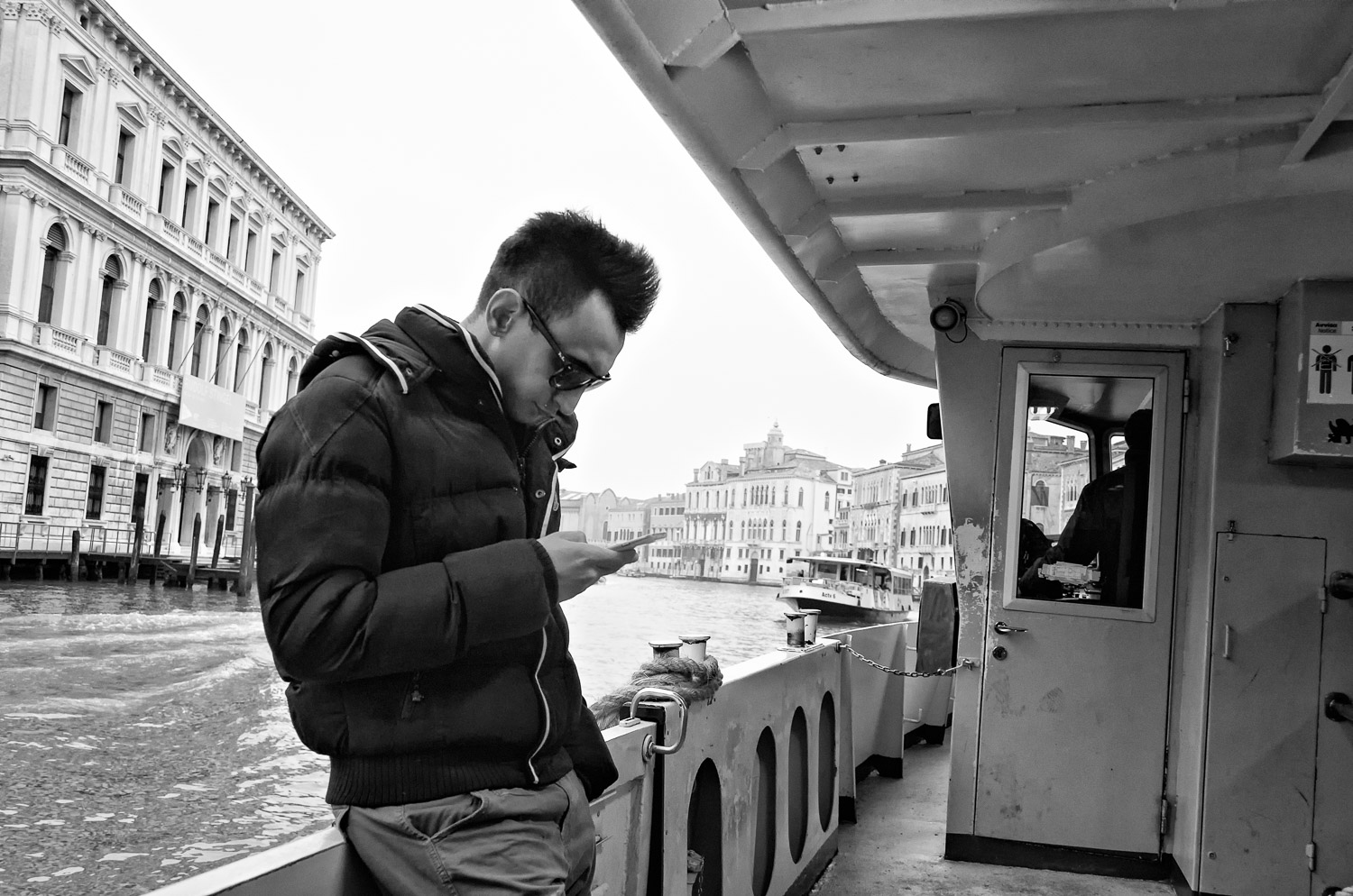 Man on Vaporetto with Phone