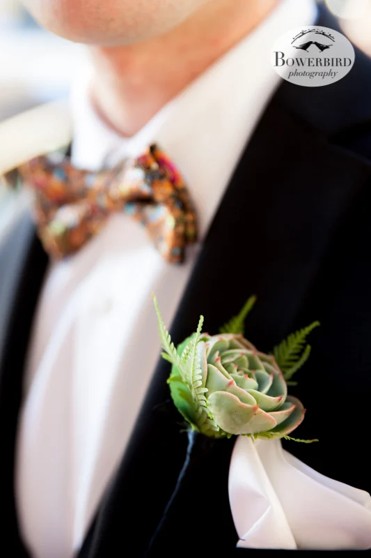 The groom looks dashing, with a custom bow-tie, succulent boutonniere with the smallest ferns, and silk handkerchief. © Bowerbird Photography 2013; Mark Hopkins Hotel, San Francisco.