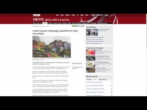Screenshot of a BBC News webpage with a headline about a peace message painted on an Iraqi mountain, featuring an image of a colorful mountain painting.