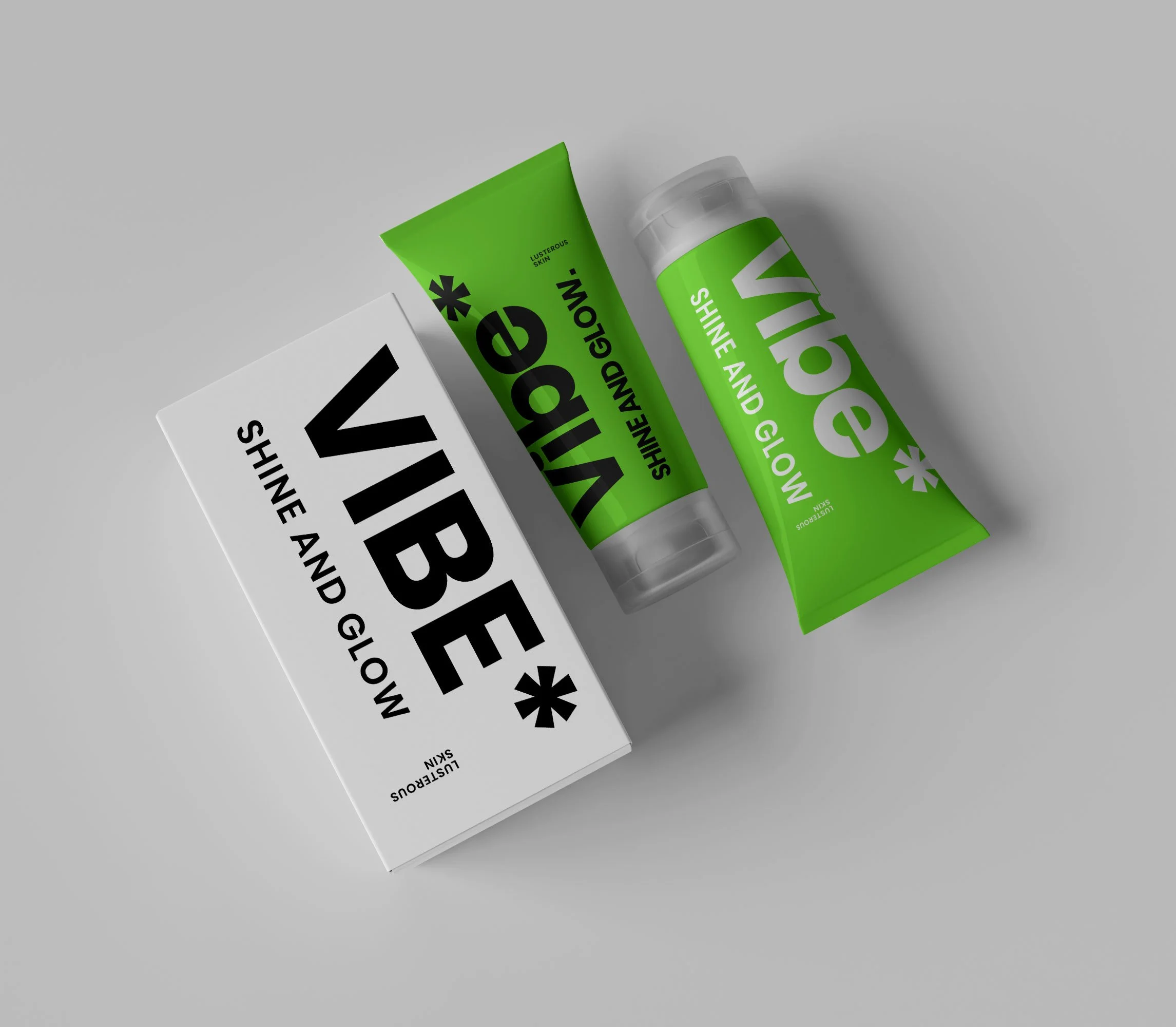 Two green and white Vibe skincare product containers and a box with Vibe branding, on a plain surface.