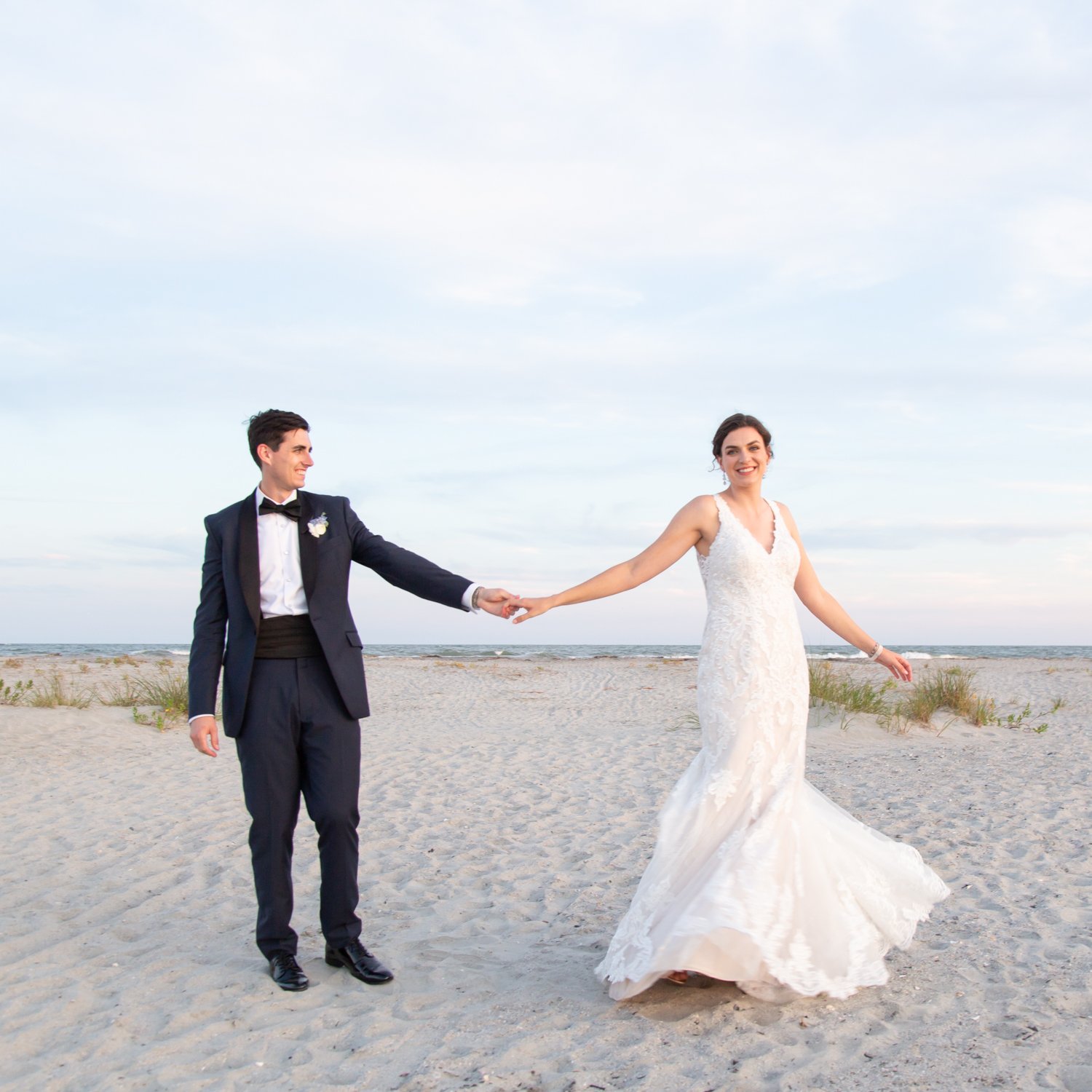 bride and groom twirling at Isle of Palms Citadel beach house wedding