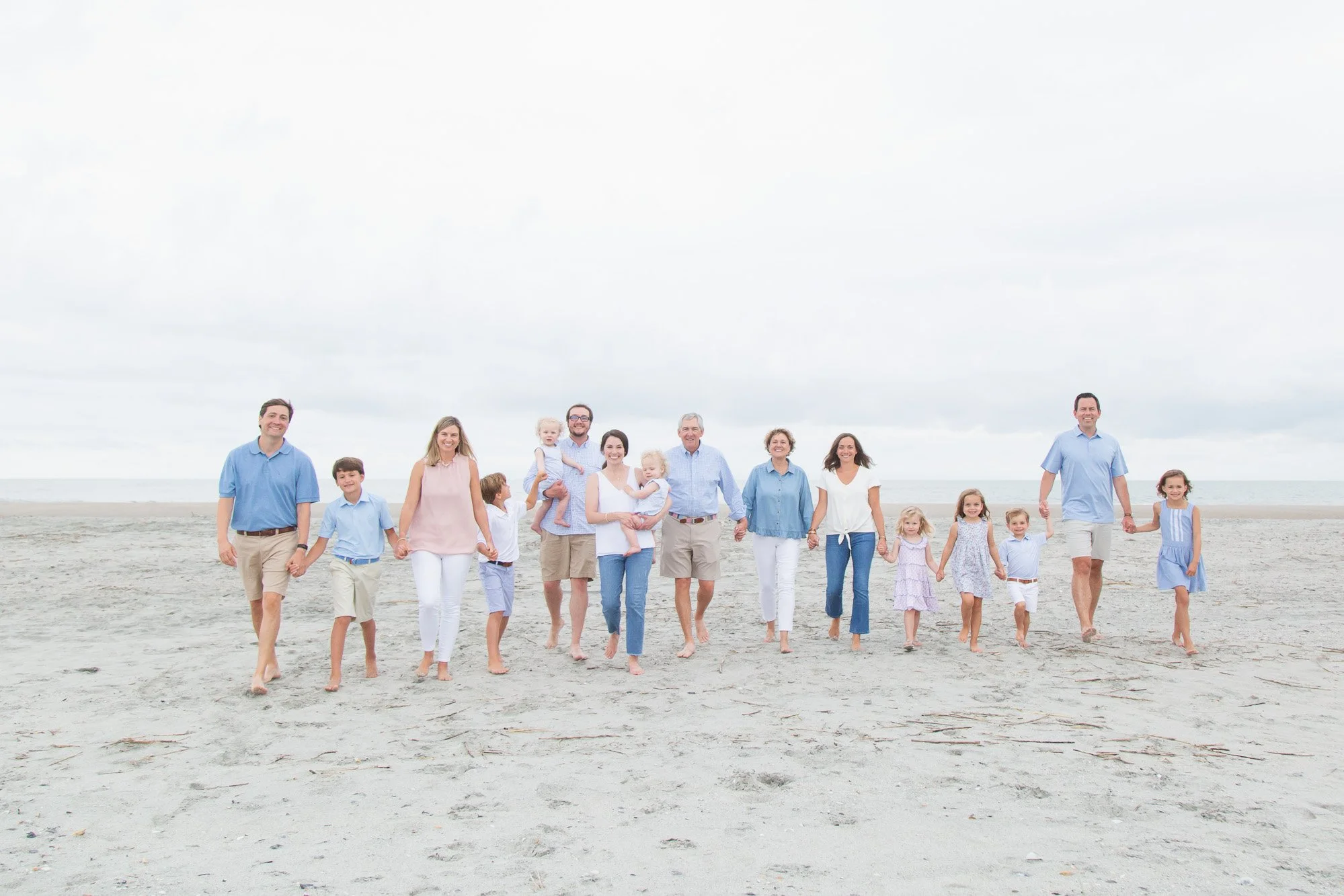 Extended family beach portrait with blues and pink palette