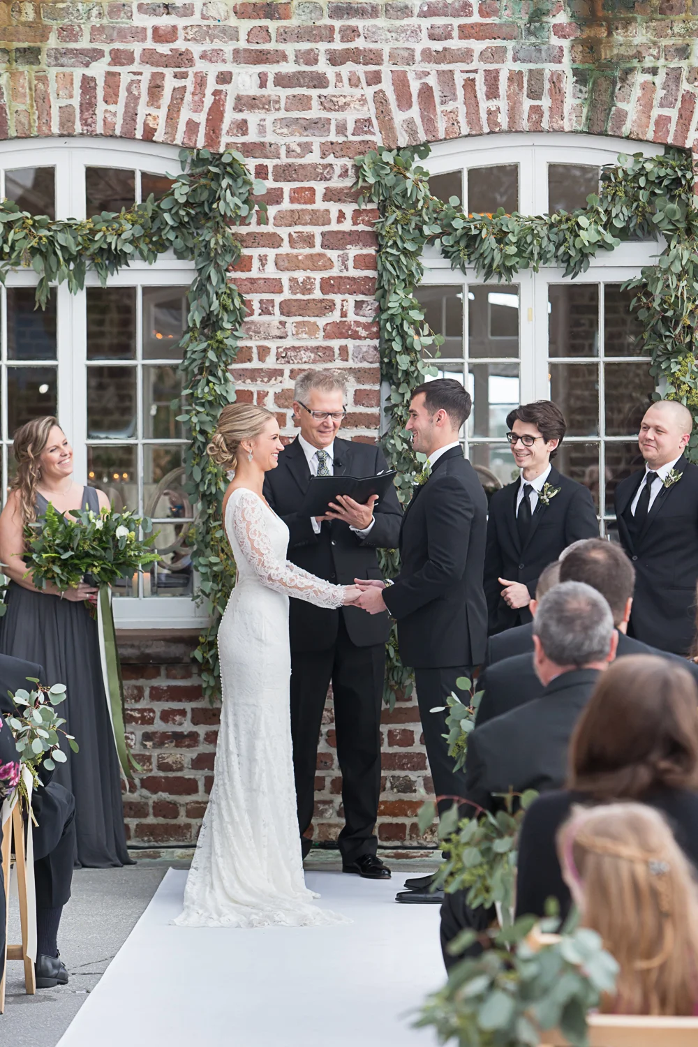 bride and groom saying vows at Historic Rice Mill