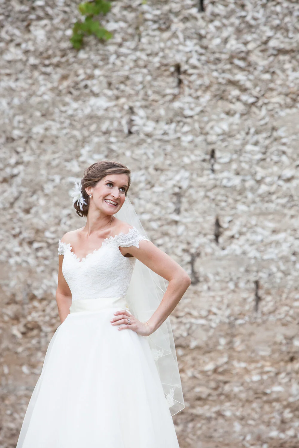 bride in front of oyster shell wall