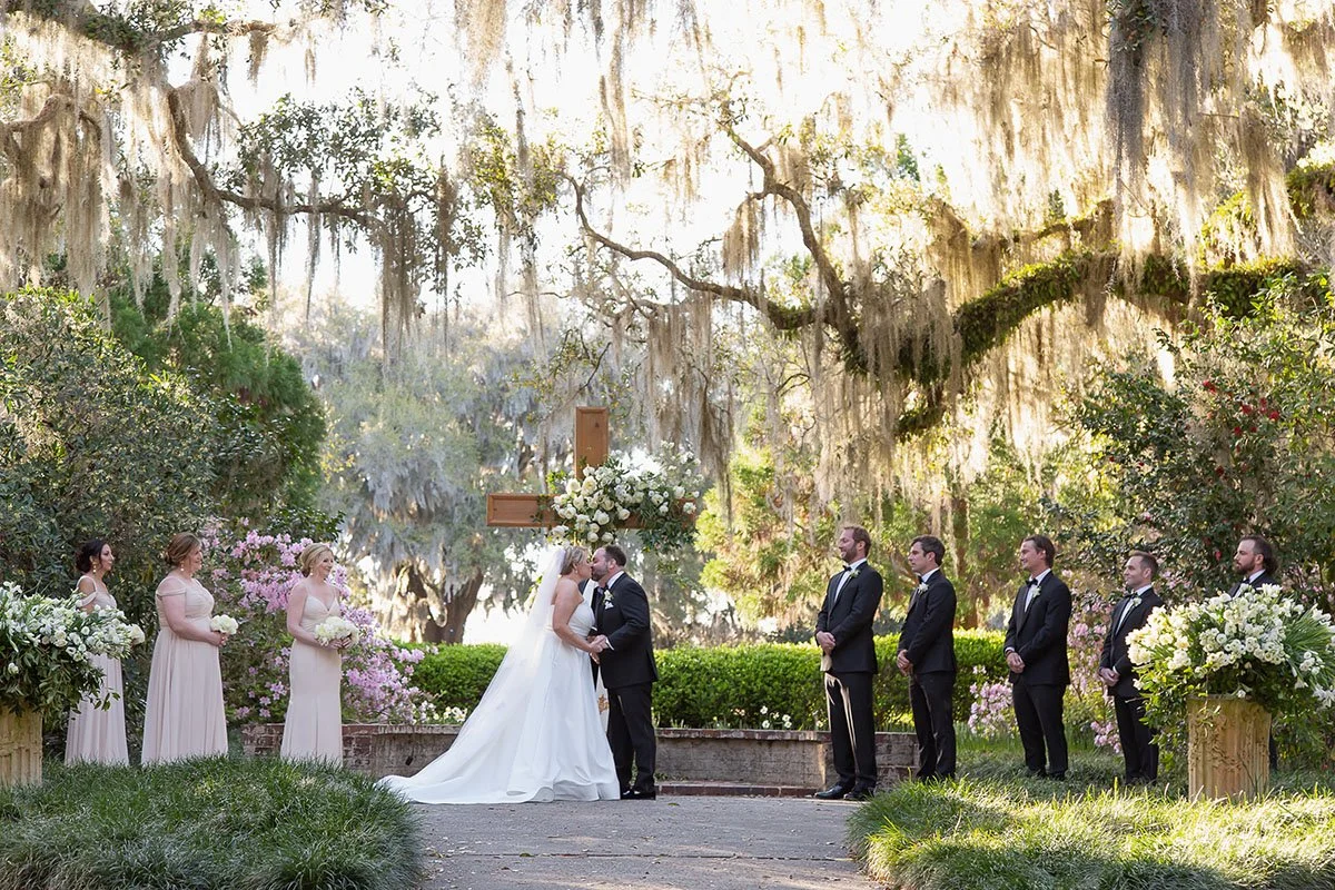couple kissing under oaks at Brookgreen Gardens