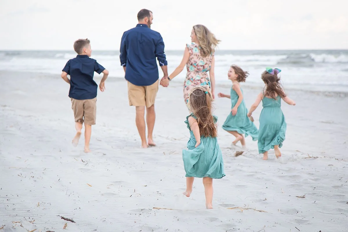 kiddos chasing parents on the beach