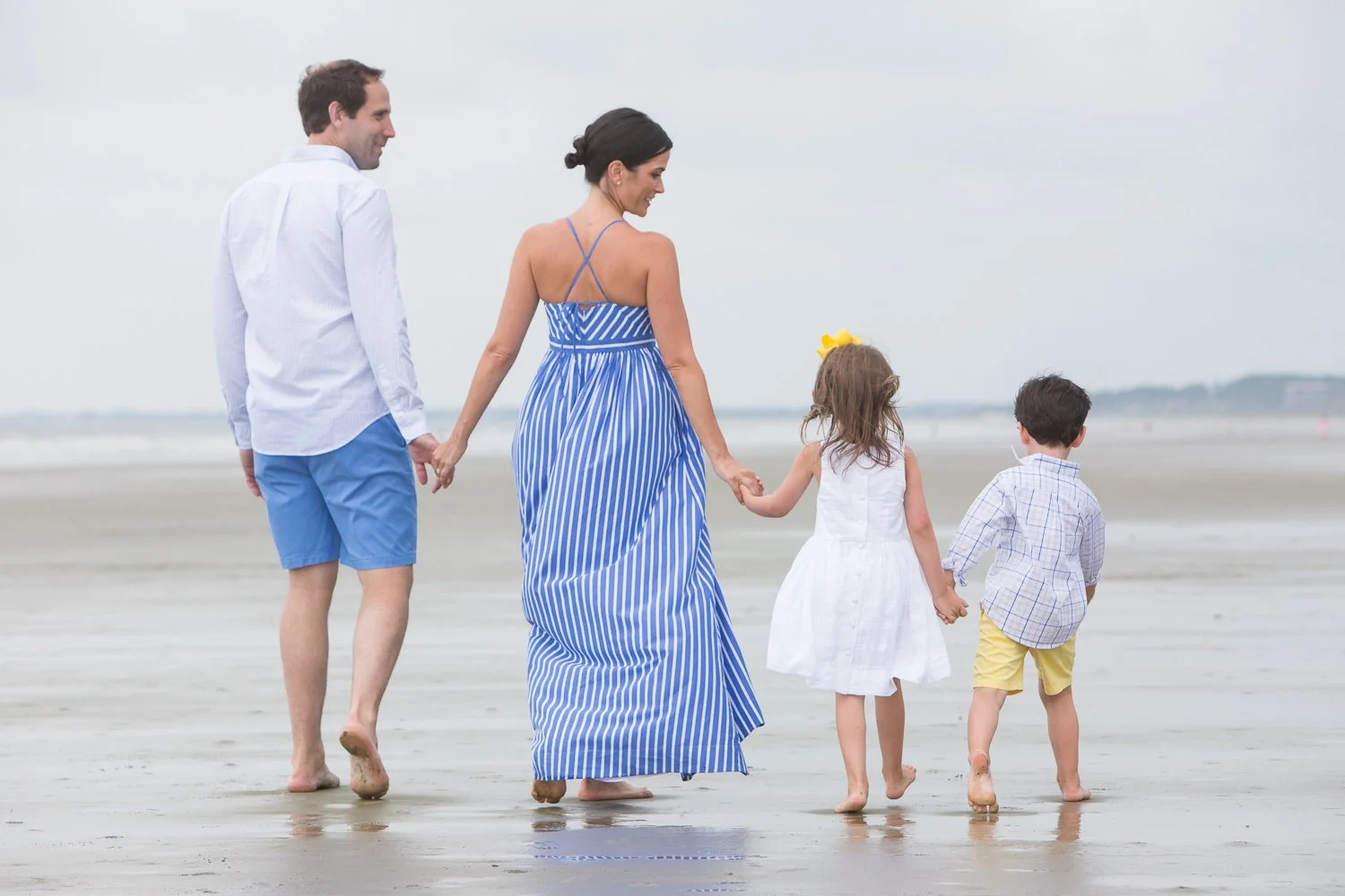 candid of family walking on the beach