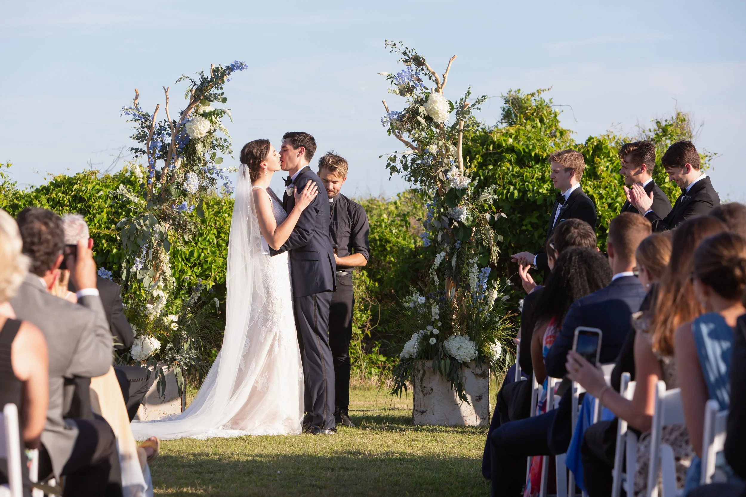 couple first kiss in outdoors seaside ceremony