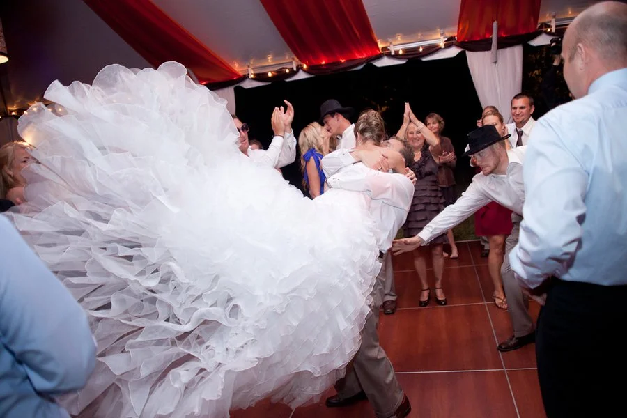 groom twirling bride and dress flying