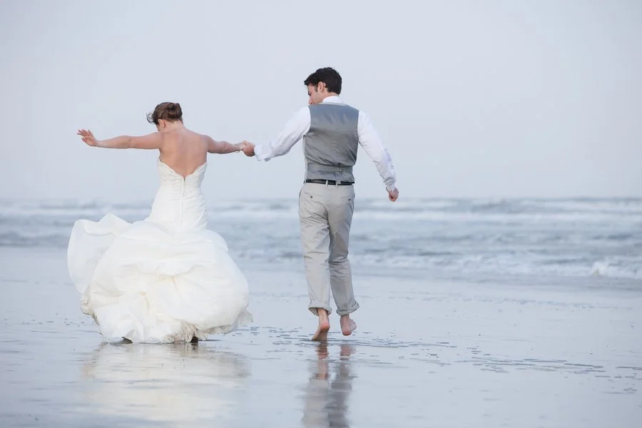bride-groom-skipping-on-beach.jpg
