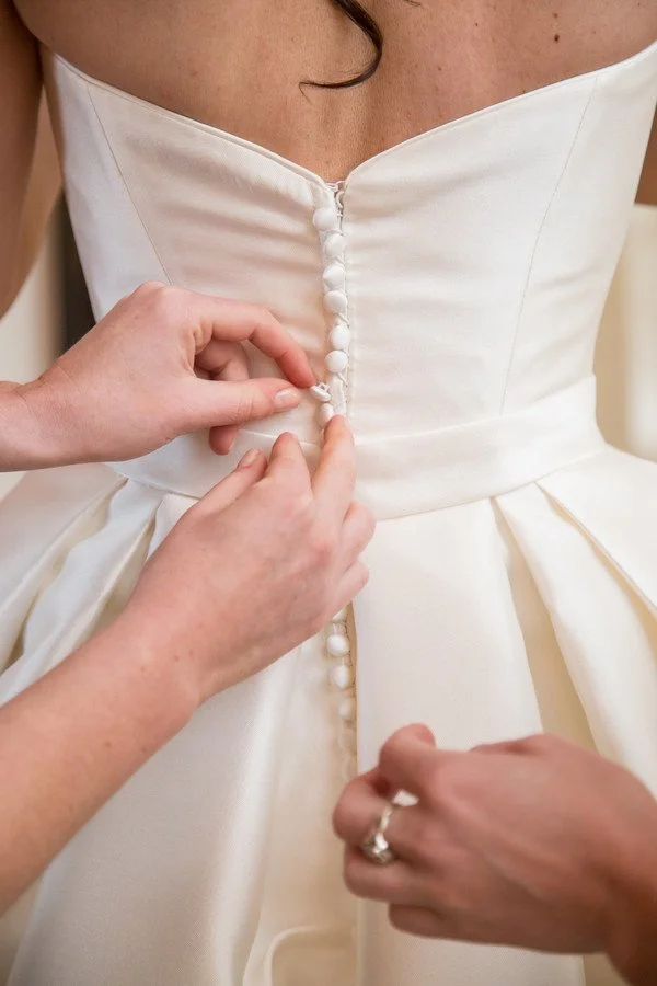 buttoning-up-bride.jpg