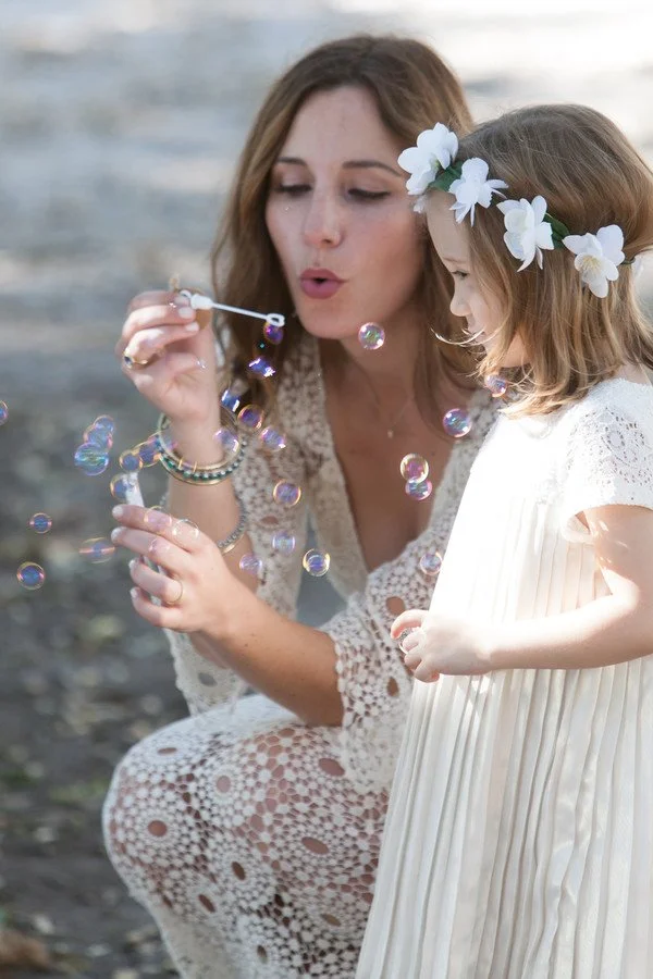 bride-blowing-bubbles-flower-girl.jpg