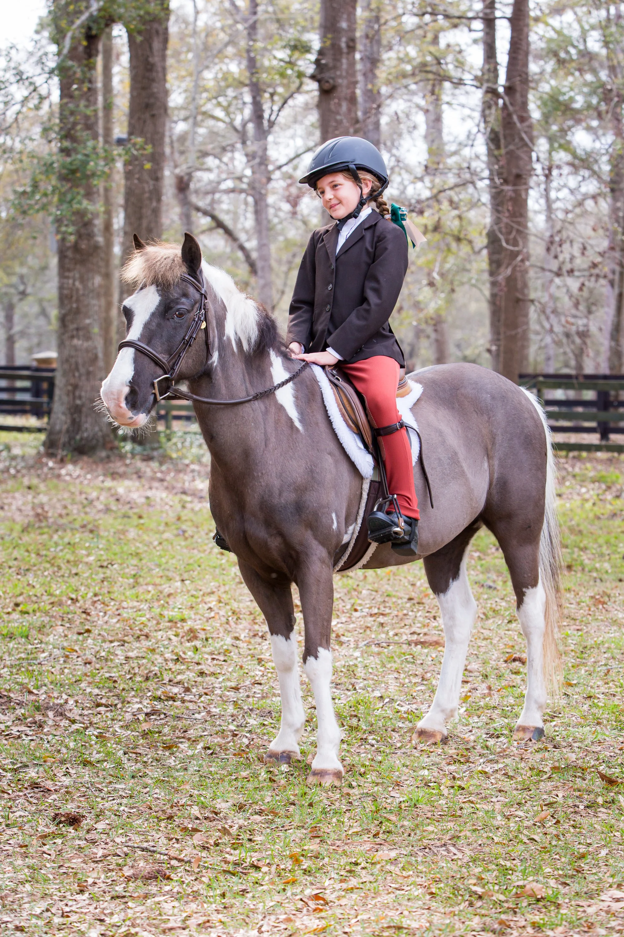young equestrian sitting on paint pony