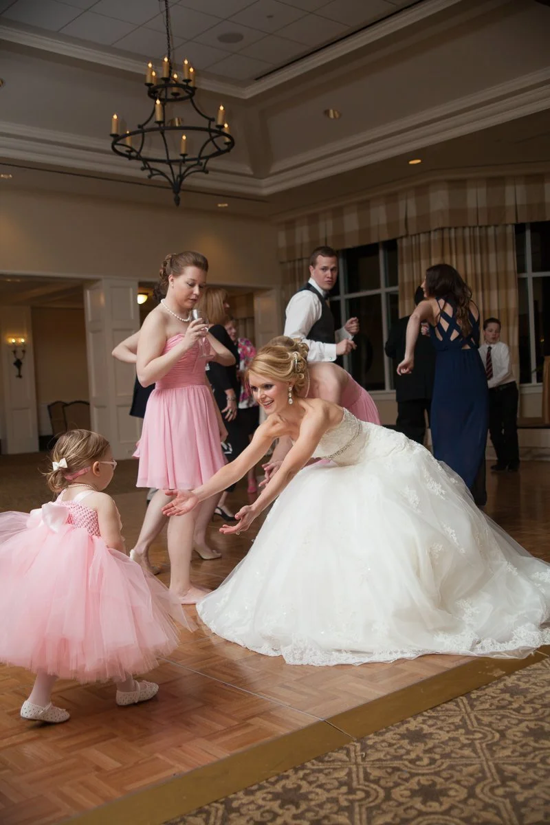 flower girl running to bride on dance floor