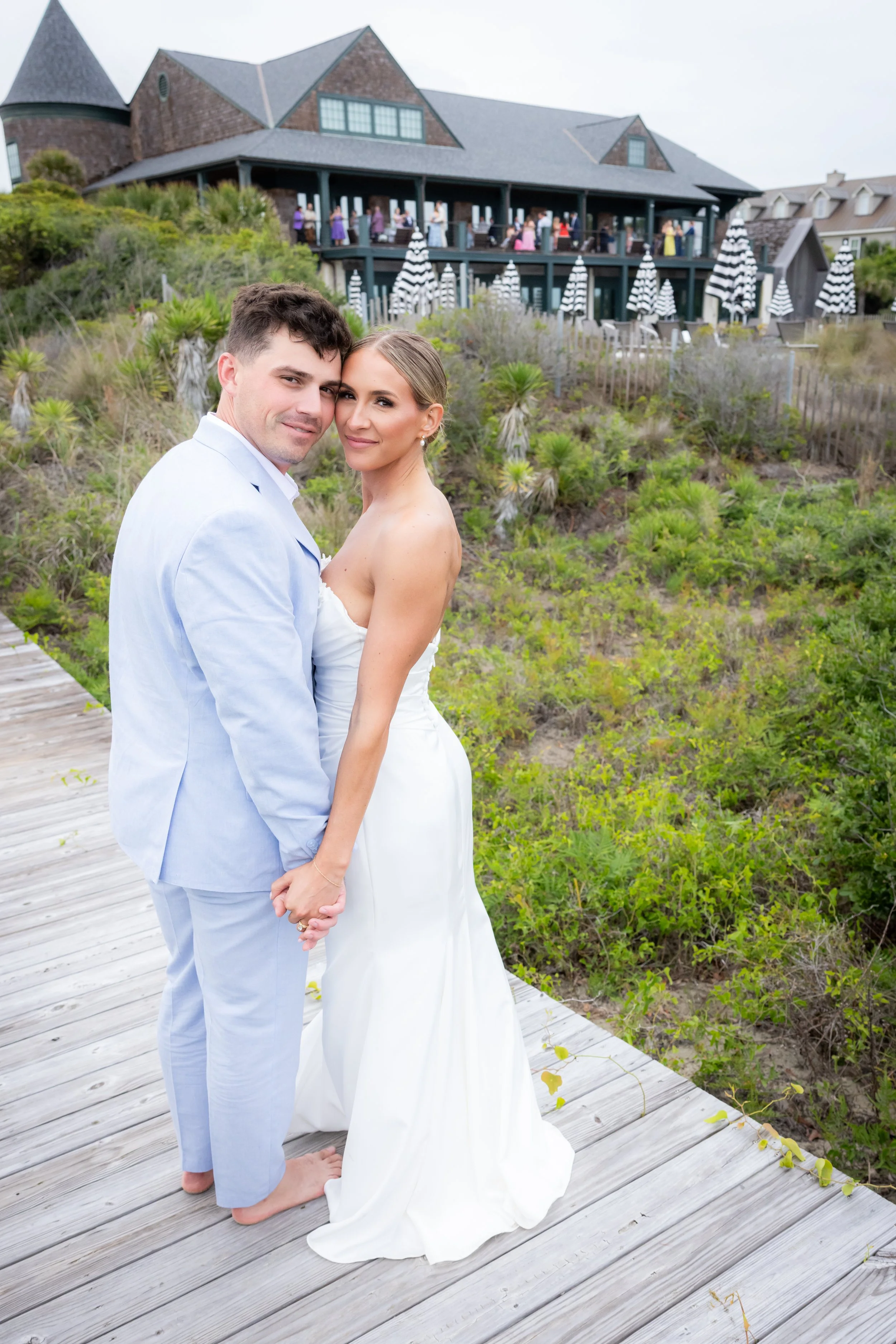 couple with Sandcastle in background