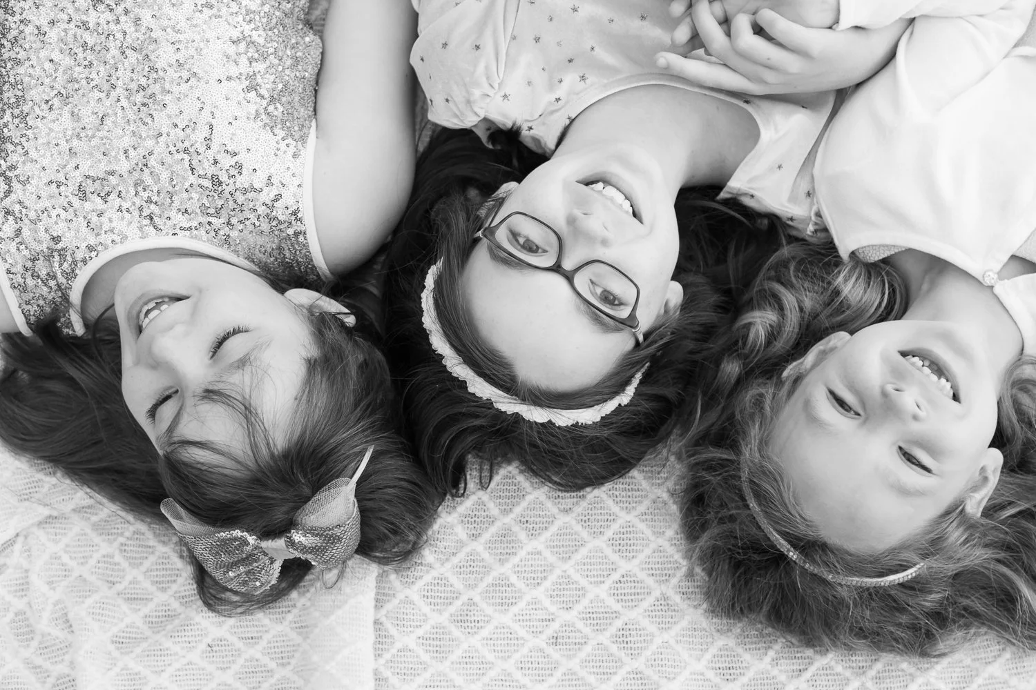 sisters looking up from blanket