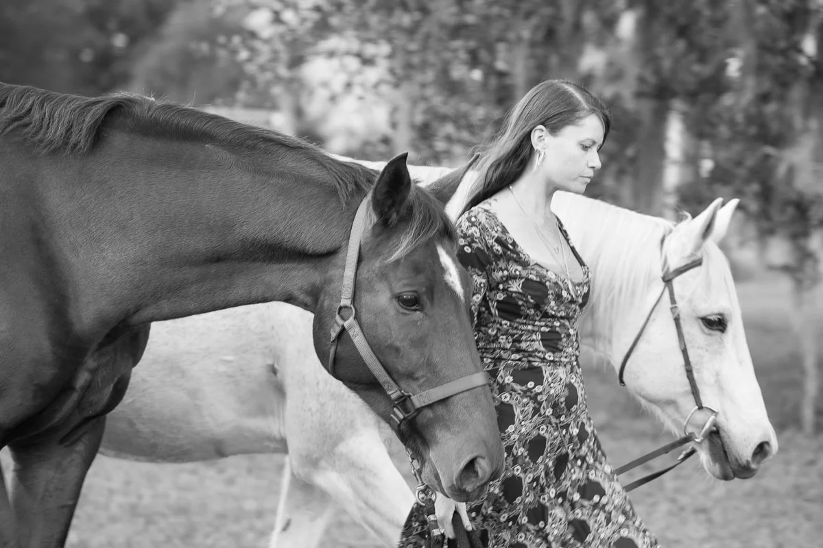 women leading two horses
