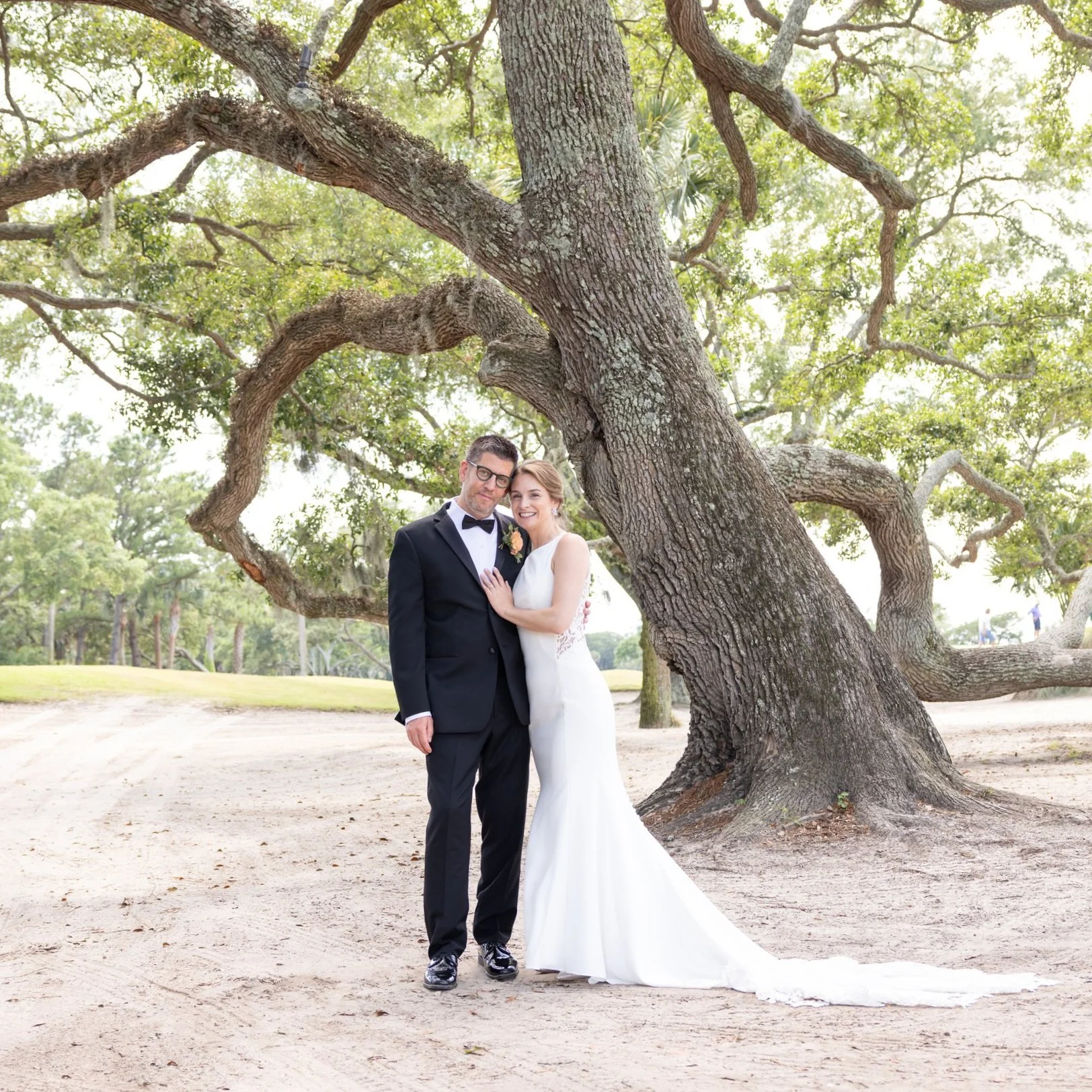 bride and groom portrait under a live oak on golf course